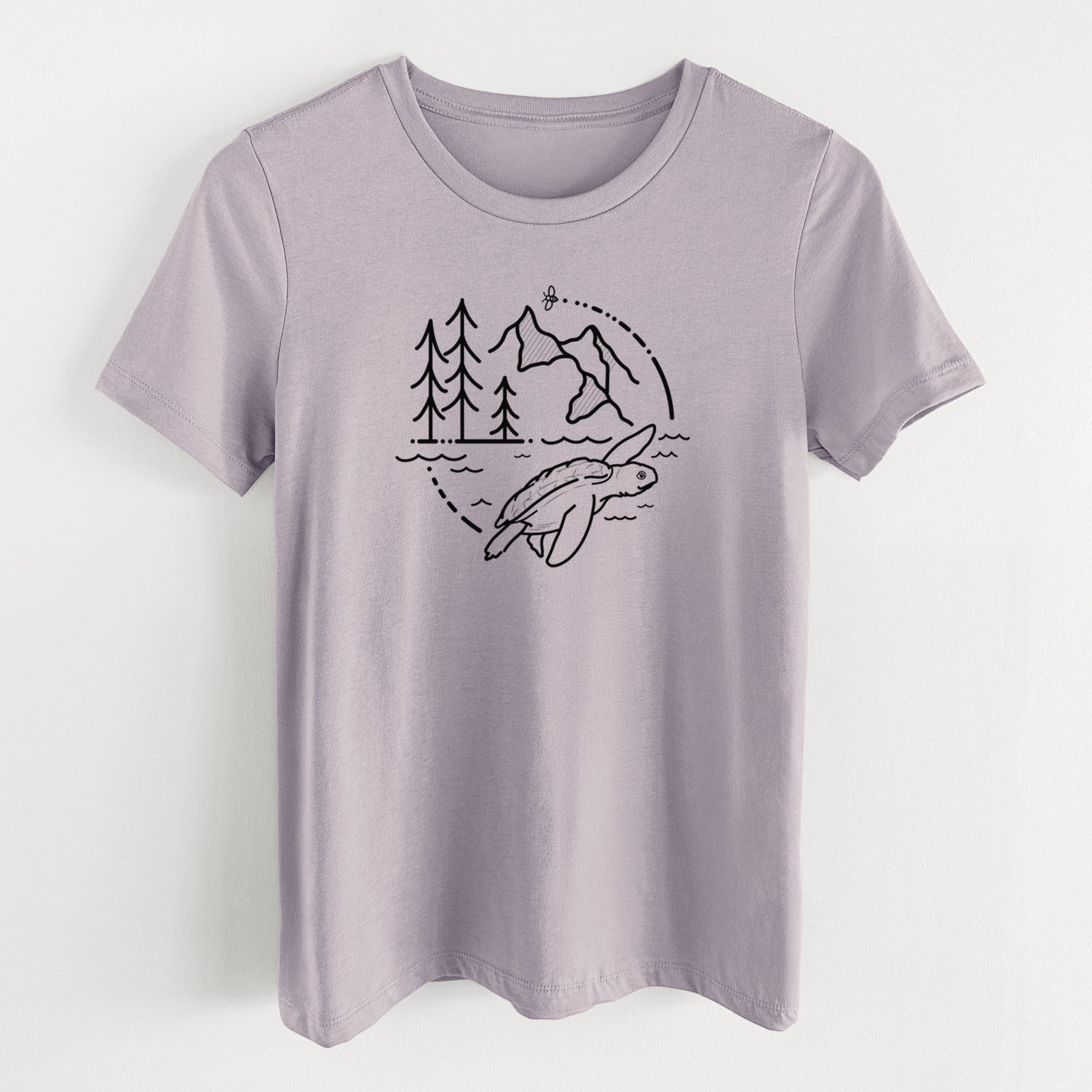 Light violet women's relaxed fit cotton t-shirt laid flat, printed with a black line art circle connecting pine trees, mountains, a bee and a Kemp's ridley sea turtle swimming.