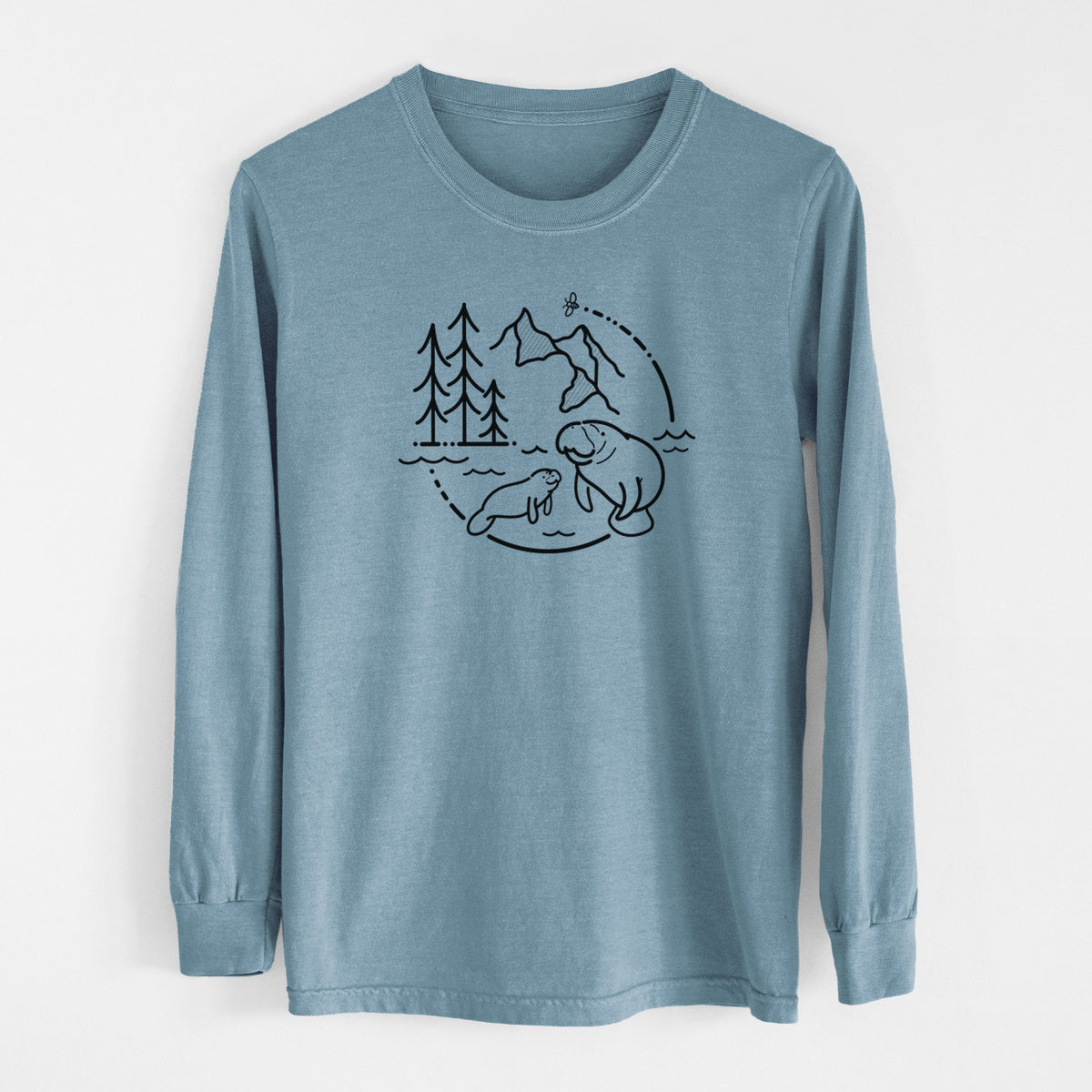 Steel blue Comfort Colors long sleeve shirt laid flat, printed with a black line art circle connecting pine trees, mountains, a bee and two manatees swimming in water.
