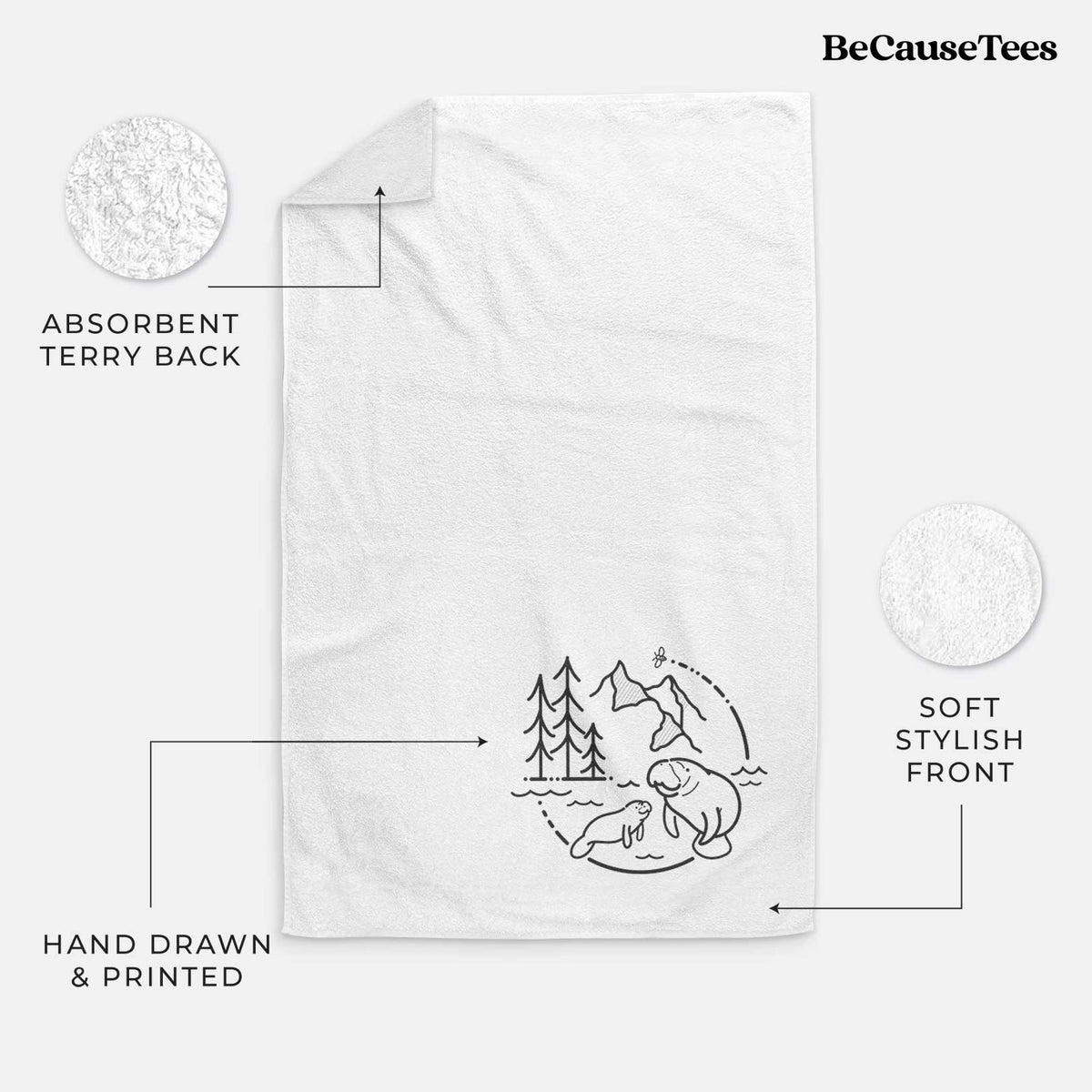 White hand towel printed with a black line art circle connecting pine trees, mountains, a bee and two manatees swimming in water.