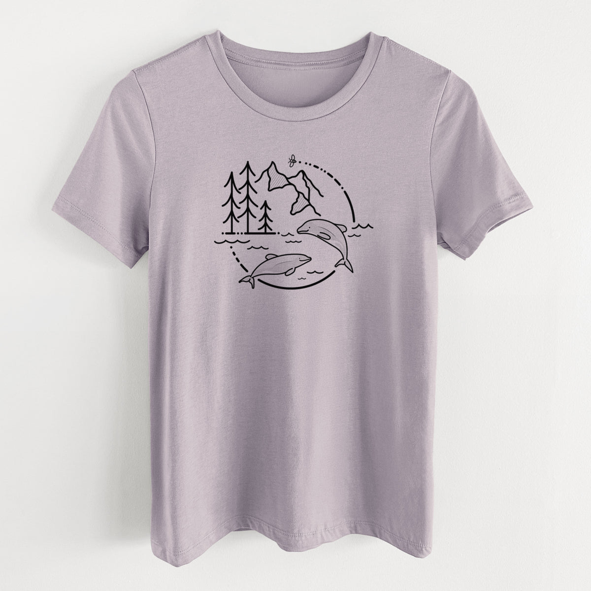 Light violet women's relaxed fit cotton t-shirt laid flat, printed with a black line art circle connecting pine trees, mountains, a bee and two Maui dolphins leaping from the waves.