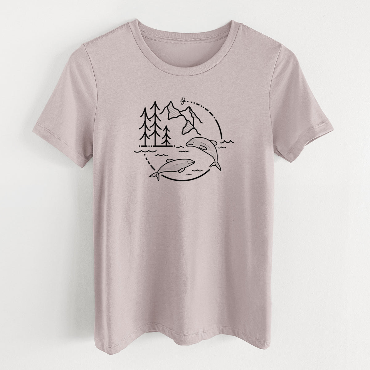 Pink gravel women's relaxed fit cotton t-shirt laid flat, printed with a black line art circle connecting pine trees, mountains, a bee and two Maui dolphins leaping from the waves.