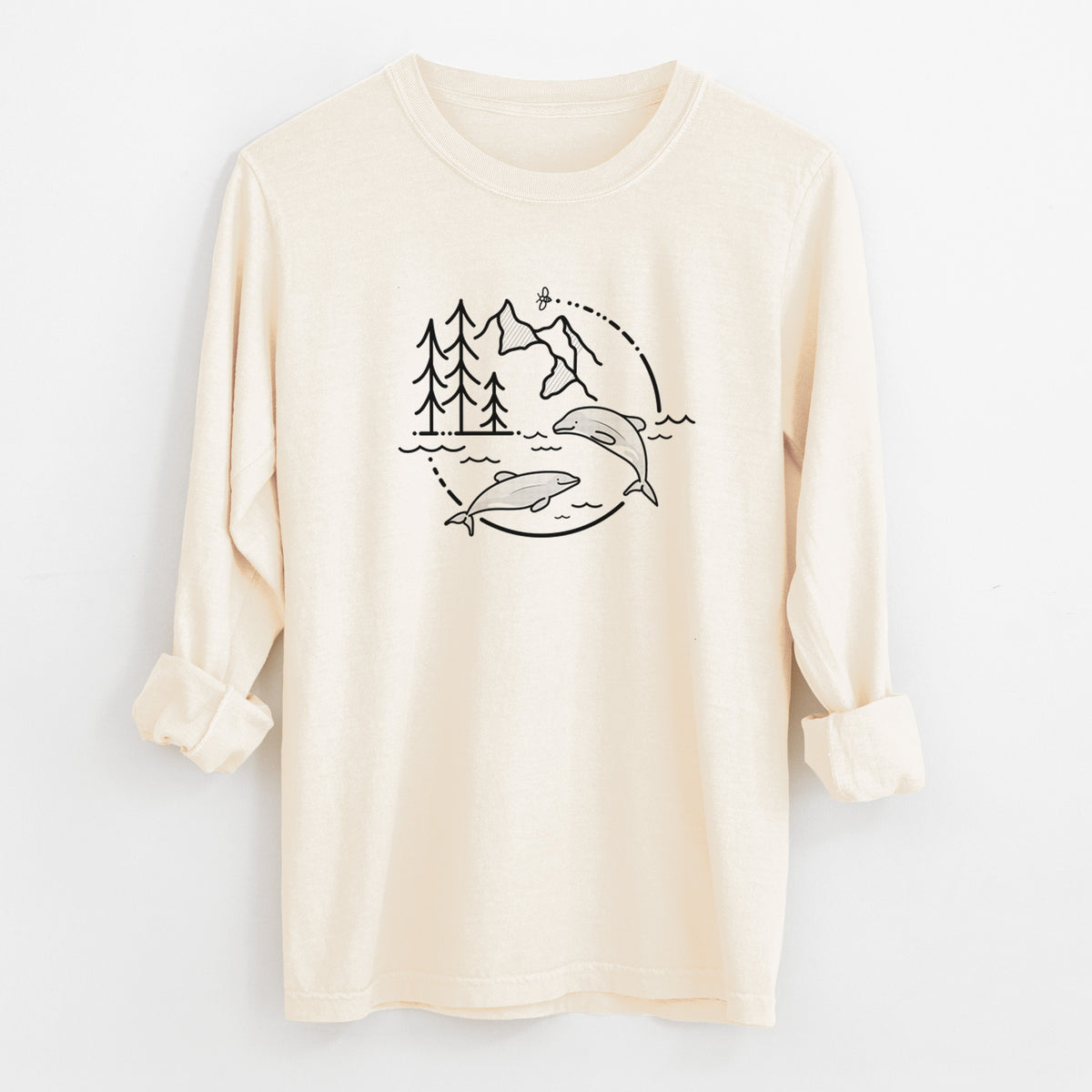 Ivory Comfort Colors long sleeve shirt laid flat with the cuffs rolled, printed with a black line art circle connecting pine trees, mountains, a bee and two Maui dolphins leaping from the waves.