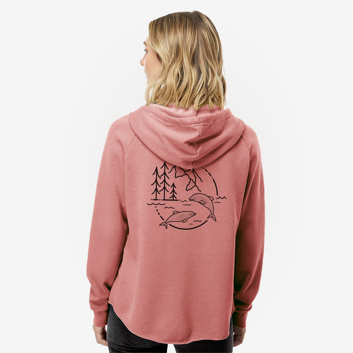 Woman wearing a dusty rose women's Cali Wave zip-up sweatshirt printed with a black line art circle connecting pine trees, mountains, a bee and two Maui dolphins leaping from the waves, seen from behind.