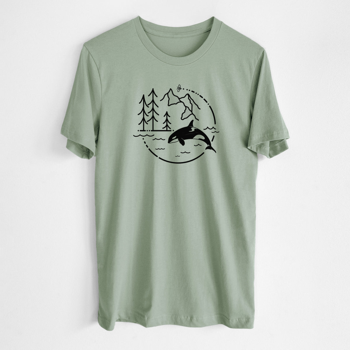 Sage green lightweight cotton t-shirt laid flat, printed with a black line art circle connecting pine trees, mountains, a bee and an orca leaping from ocean waves.