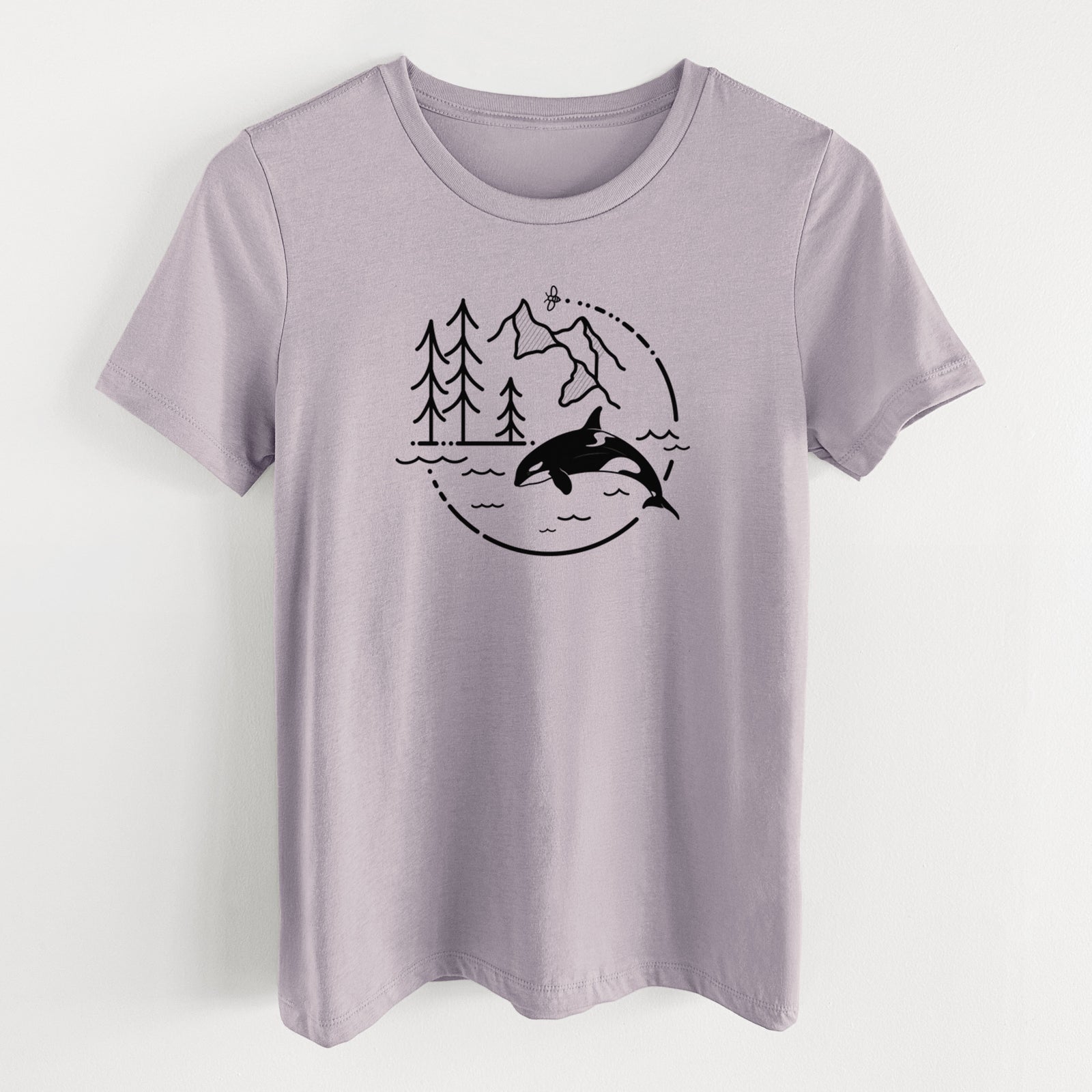 Light violet women's relaxed fit cotton t-shirt laid flat, printed with a black line art circle connecting pine trees, mountains, a bee and an orca leaping from ocean waves.