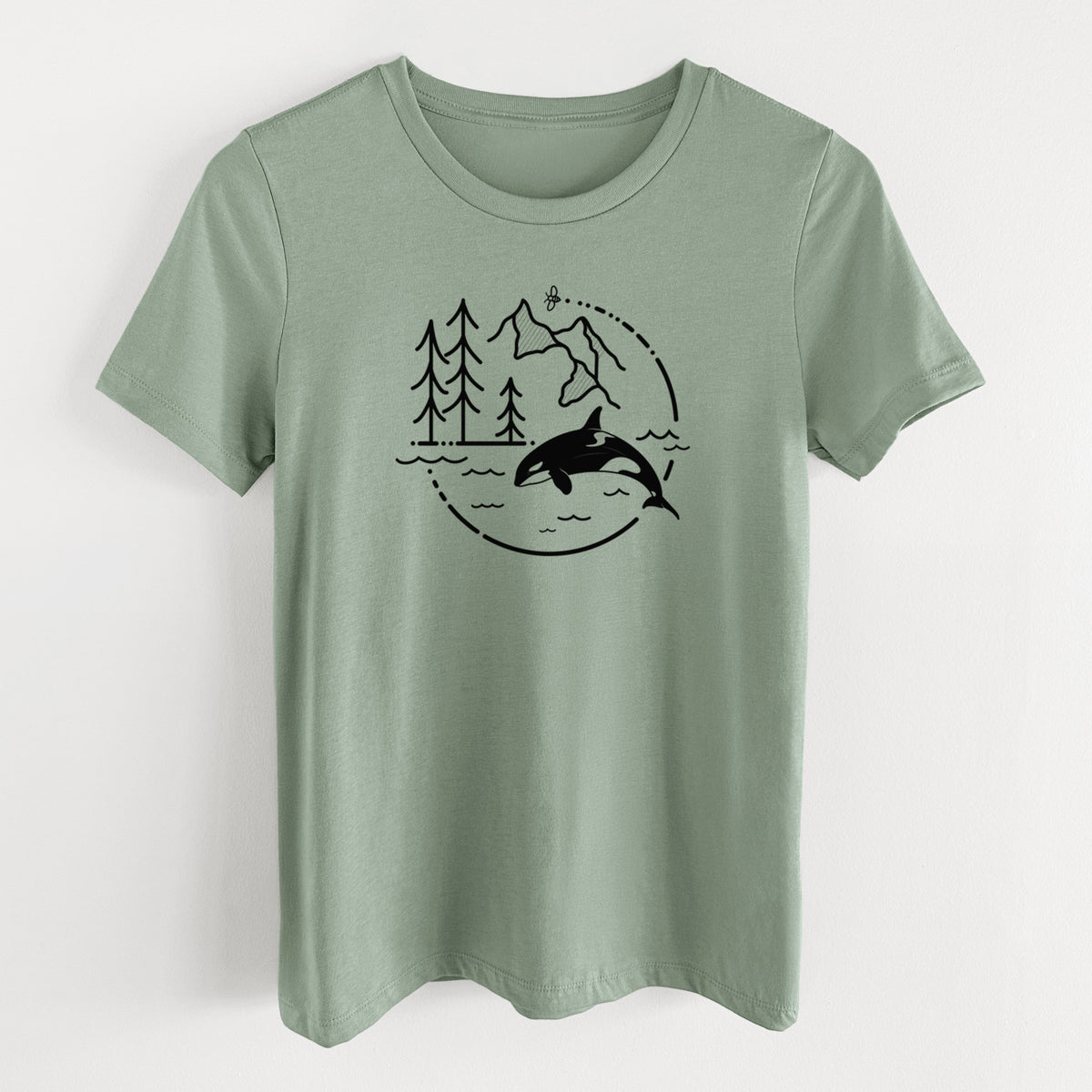 Sage green women's relaxed fit cotton t-shirt laid flat, printed with a black line art circle connecting pine trees, mountains, a bee and an orca leaping from ocean waves.