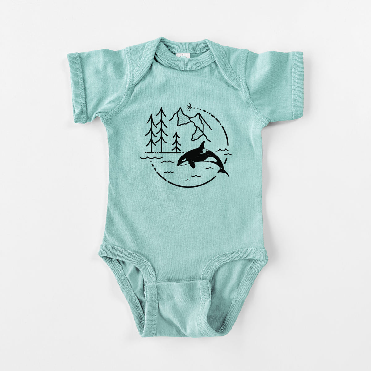 Saltwater baby bodysuit laid flat, printed with a black line art circle connecting pine trees, mountains, a bee and an orca leaping from ocean waves.