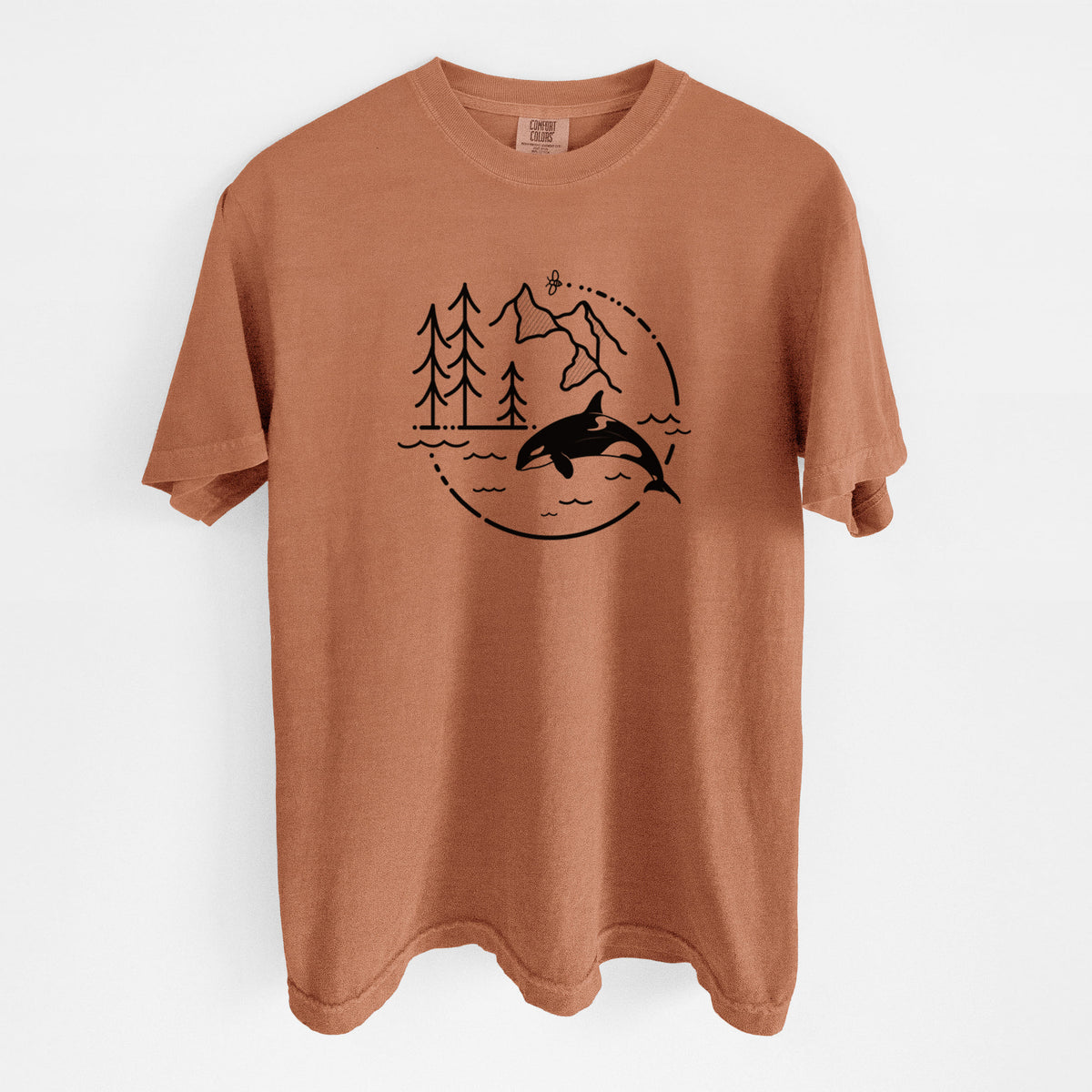 Yam burnt orange Comfort Colors t-shirt laid flat, printed with a black line art circle connecting pine trees, mountains, a bee and an orca leaping from ocean waves.
