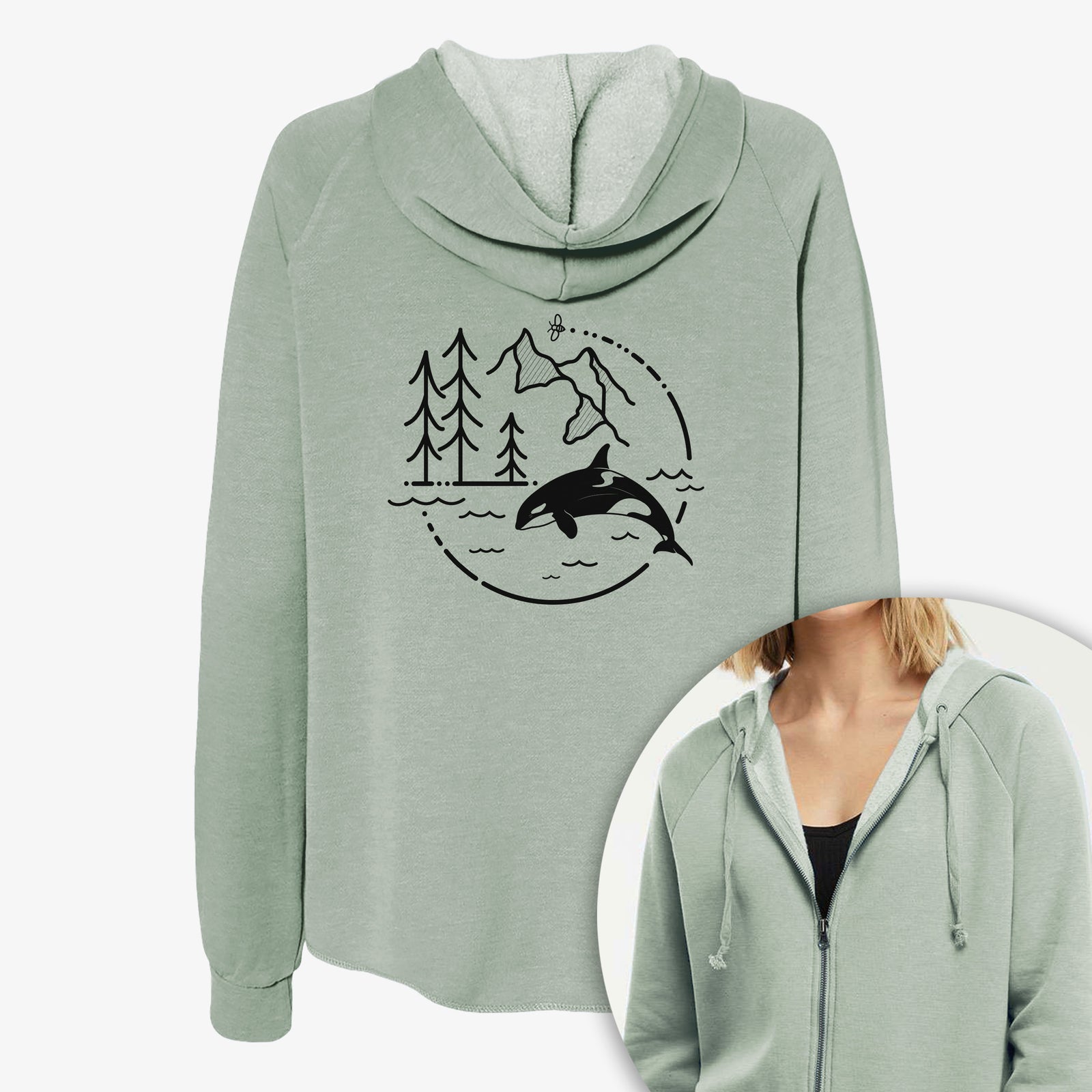 Women's Cali Wave zip-up sweatshirt printed with a black line art circle connecting pine trees, mountains, a bee and an orca leaping from ocean waves, with a close-up of the zipper.