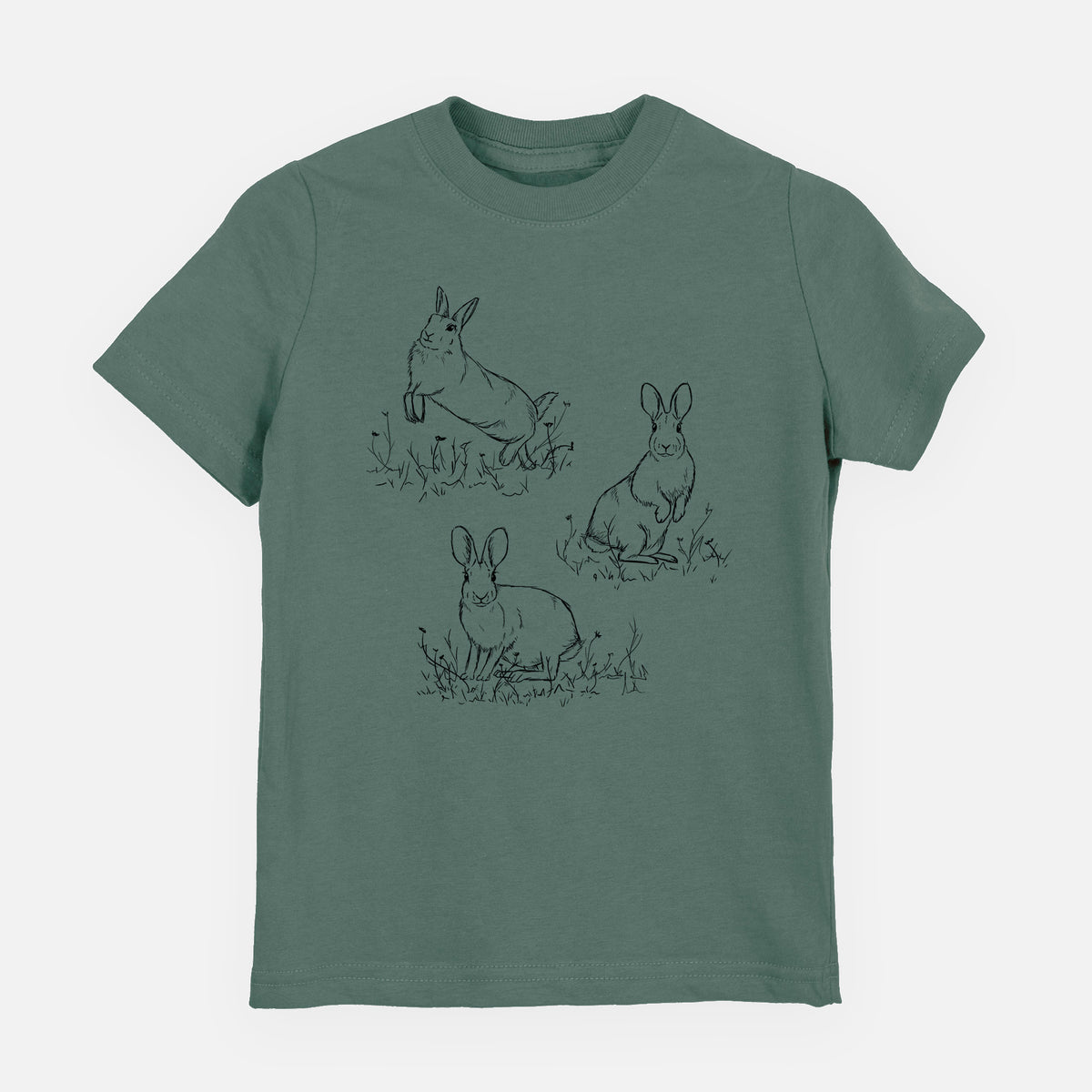 Basil green youth t-shirt laid flat, printed with a black ink illustration of three cottontail rabbits among grass and flowers.