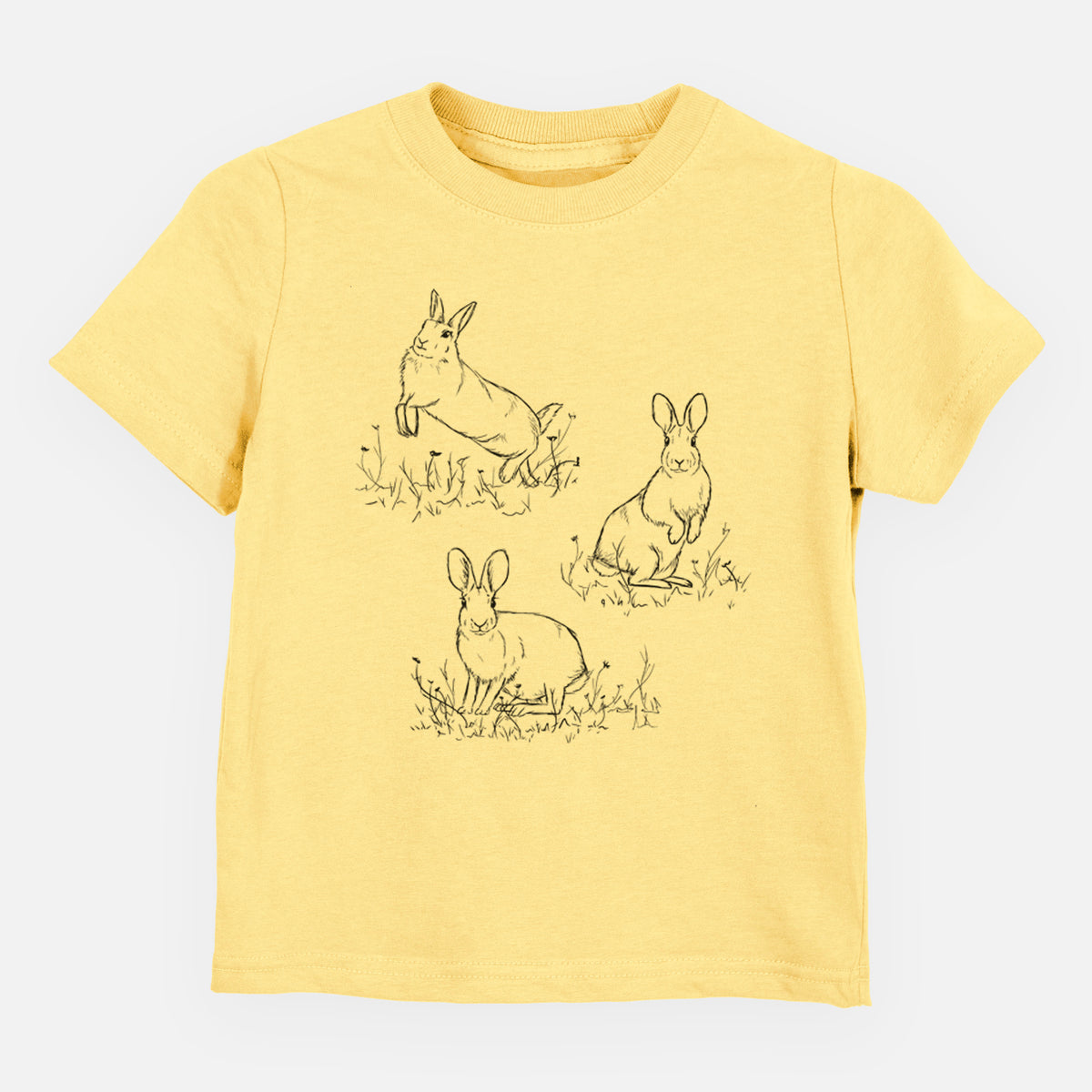 Butter yellow toddler t-shirt laid flat, printed with a black ink illustration of three cottontail rabbits among grass and flowers.