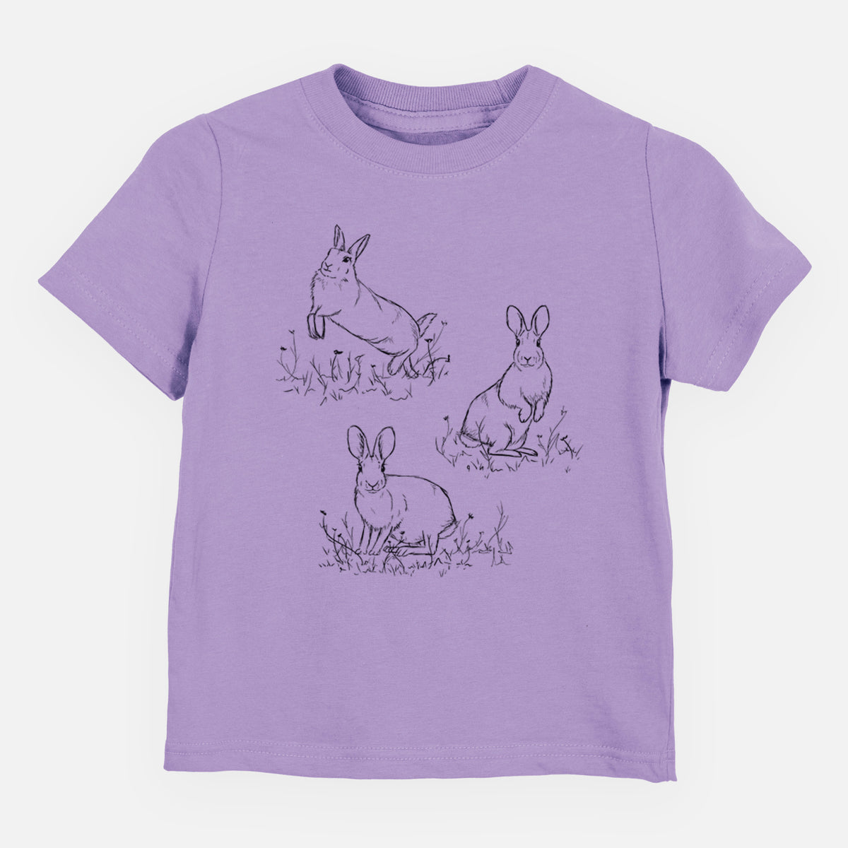 Lavender toddler t-shirt laid flat, printed with a black ink illustration of three cottontail rabbits among grass and flowers.