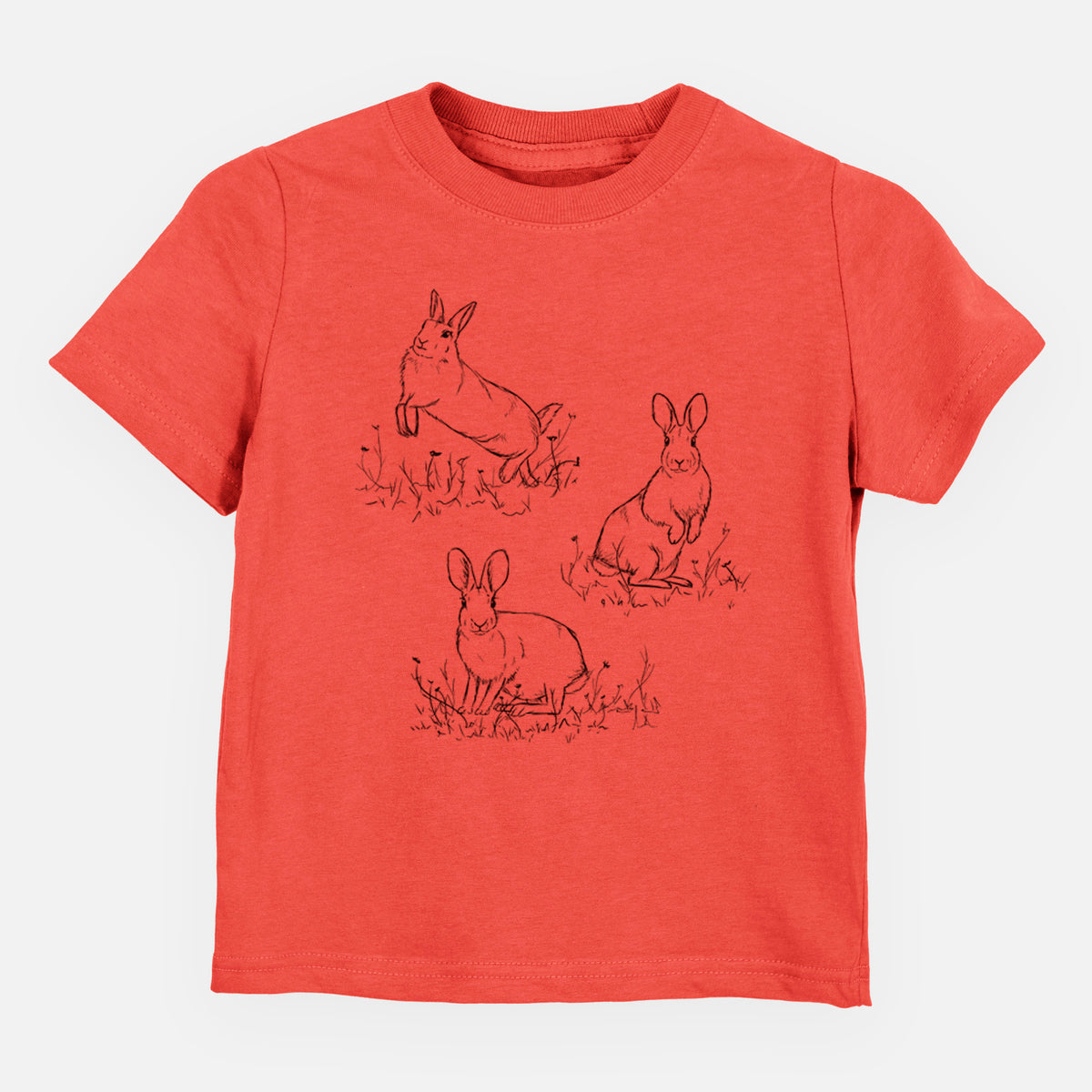 Passionfruit pink toddler t-shirt laid flat, printed with a black ink illustration of three cottontail rabbits among grass and flowers.
