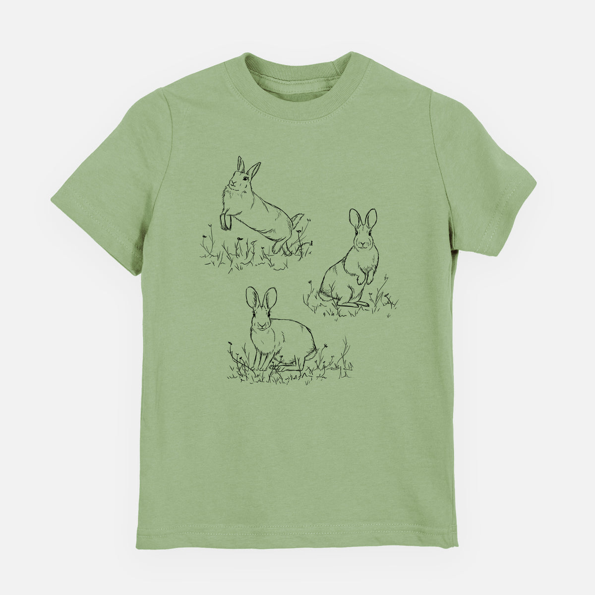 Sage green youth t-shirt laid flat, printed with a black ink illustration of three cottontail rabbits among grass and flowers.