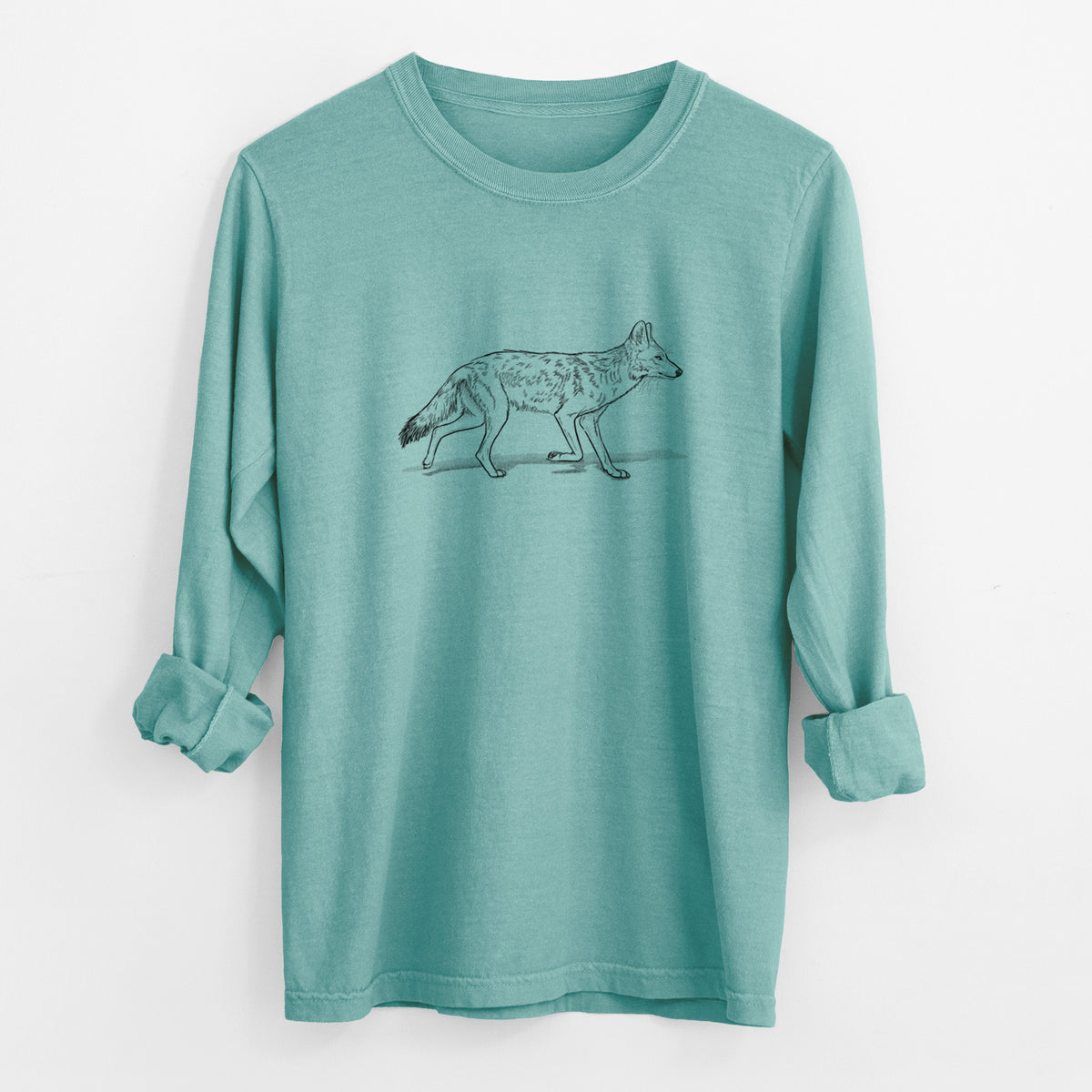 Reef green Comfort Colors long sleeve shirt laid flat with the cuffs rolled, printed with a black ink illustration of a coyote trotting.