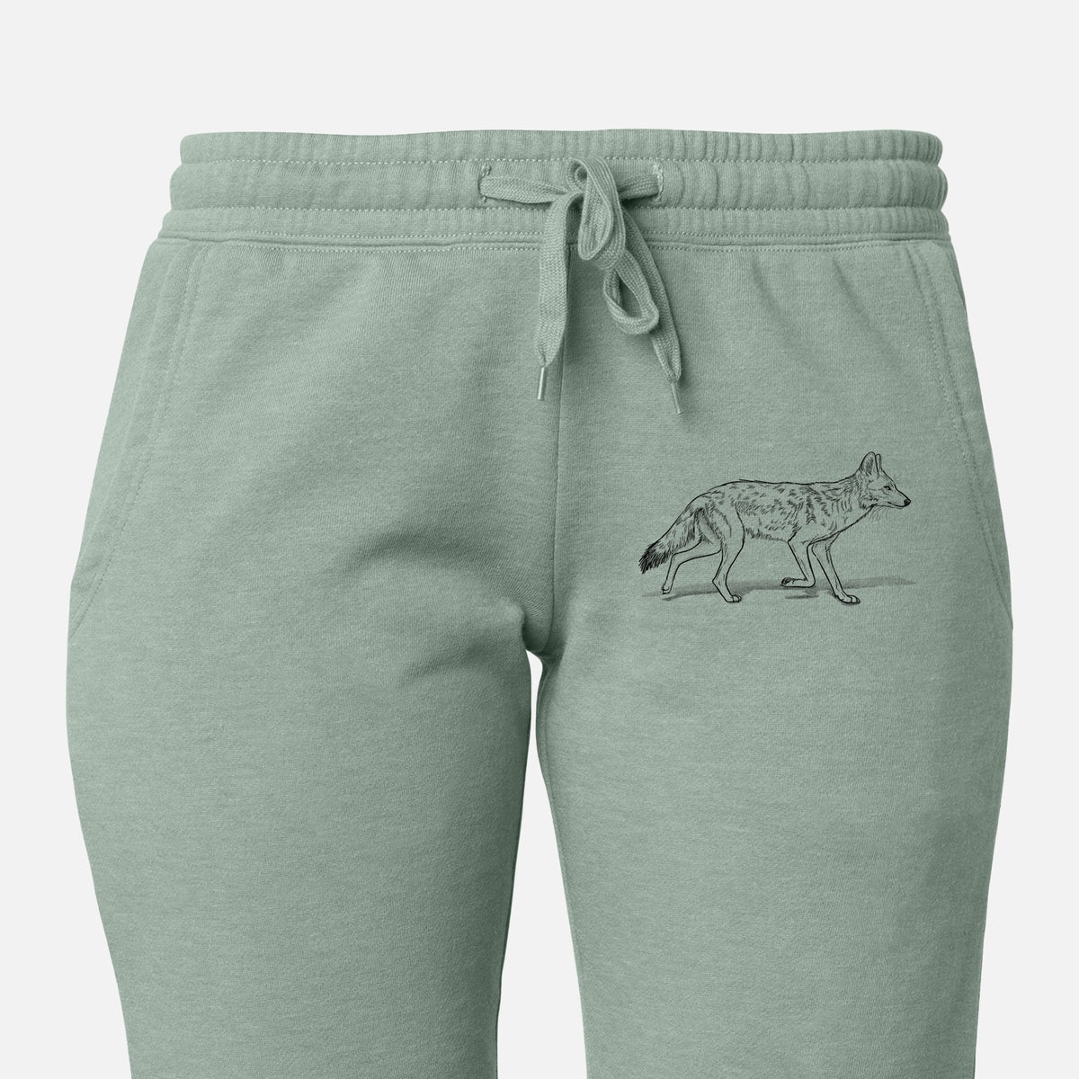 Front of sage green Cali Wave sweatpants, printed with a black ink illustration of a coyote trotting on the leg.