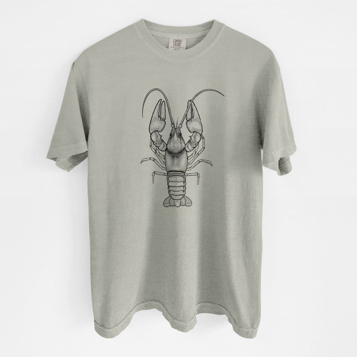 Sandstone beige Comfort Colors t-shirt laid flat, printed with a detailed black ink illustration of a crayfish with its claws raised, seen from above.