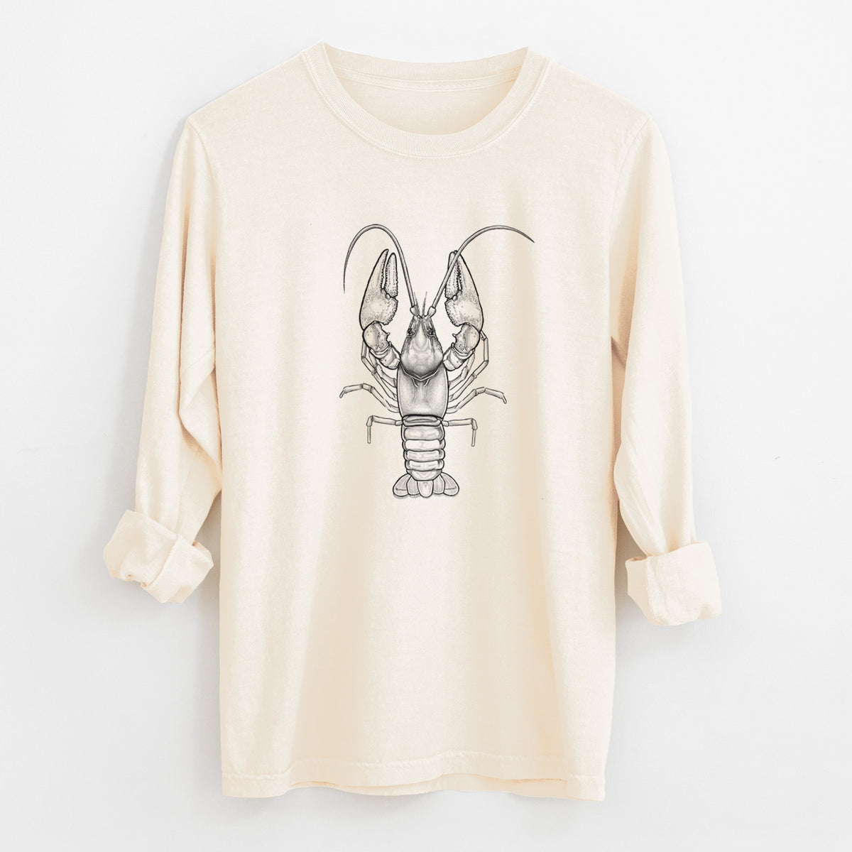 Ivory Comfort Colors long sleeve shirt laid flat with the cuffs rolled, printed with a detailed black ink illustration of a crayfish with its claws raised, seen from above.