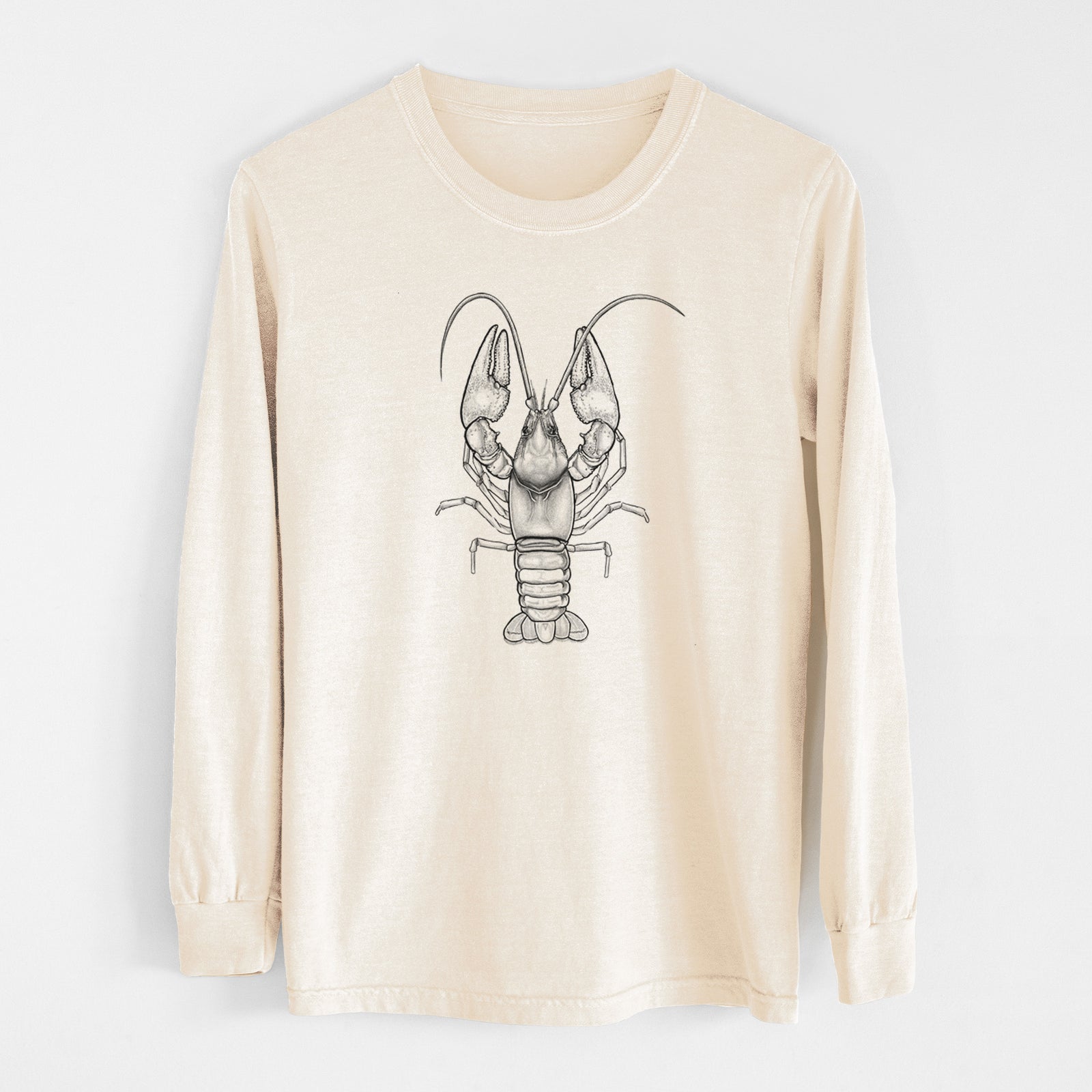 Ivory Comfort Colors long sleeve shirt laid flat, printed with a detailed black ink illustration of a crayfish with its claws raised, seen from above.