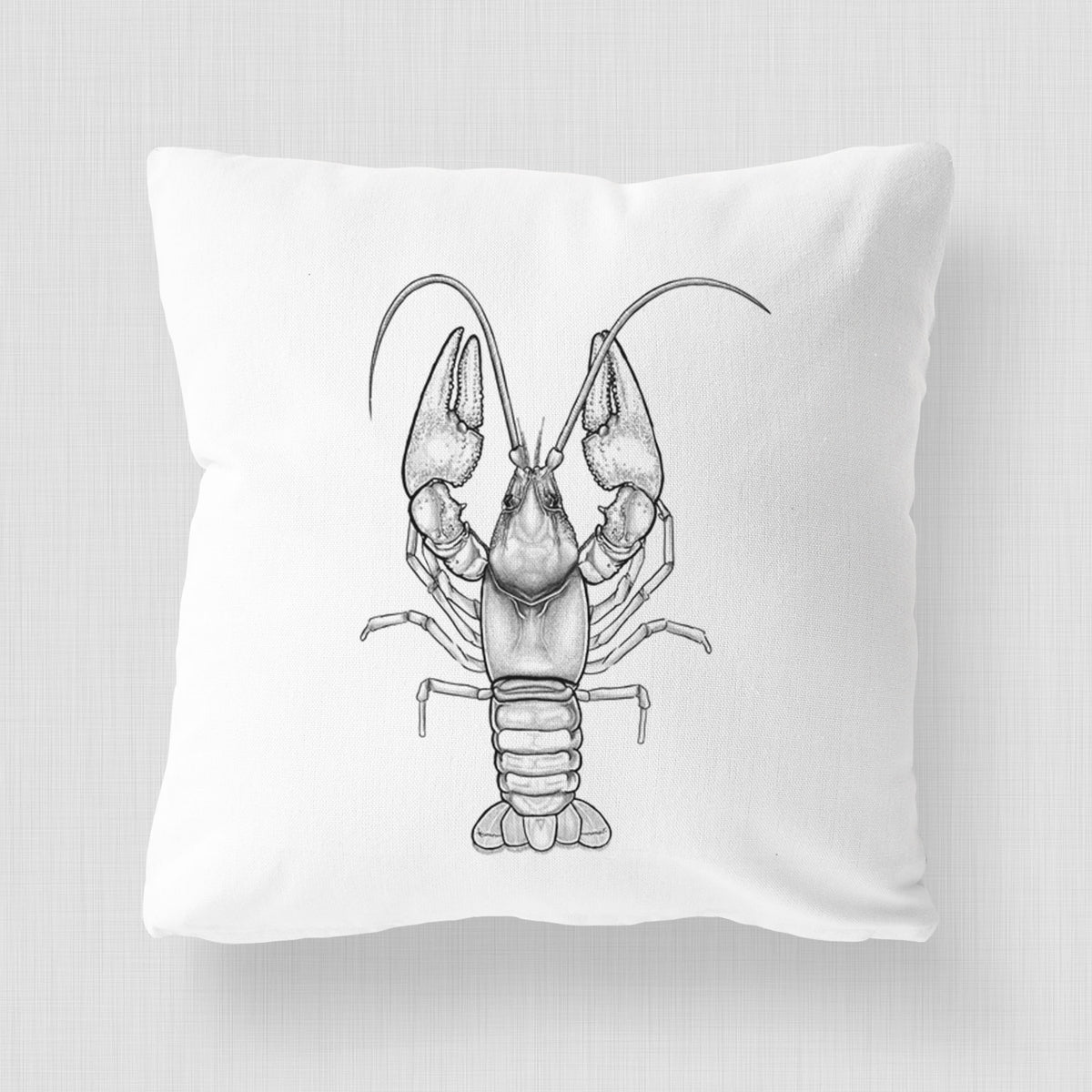 White pillow cover printed with a detailed black ink illustration of a crayfish with its claws raised, seen from above.