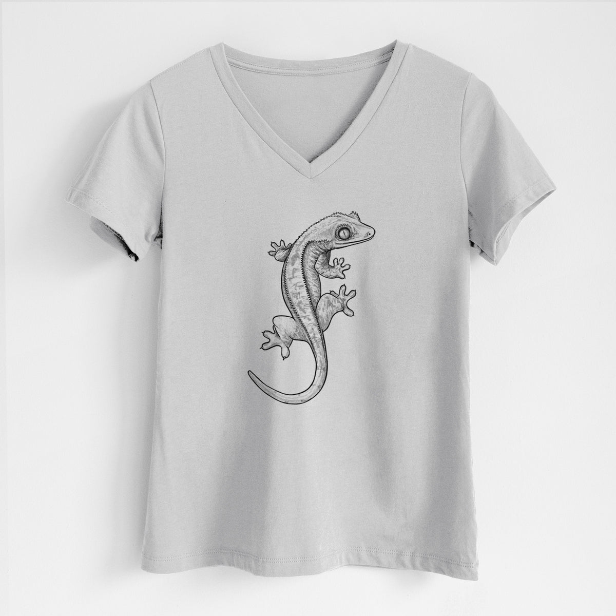 Lunar grey women's relaxed fit cotton V-neck t-shirt laid flat, printed with a detailed black ink illustration of a crested gecko climbing.