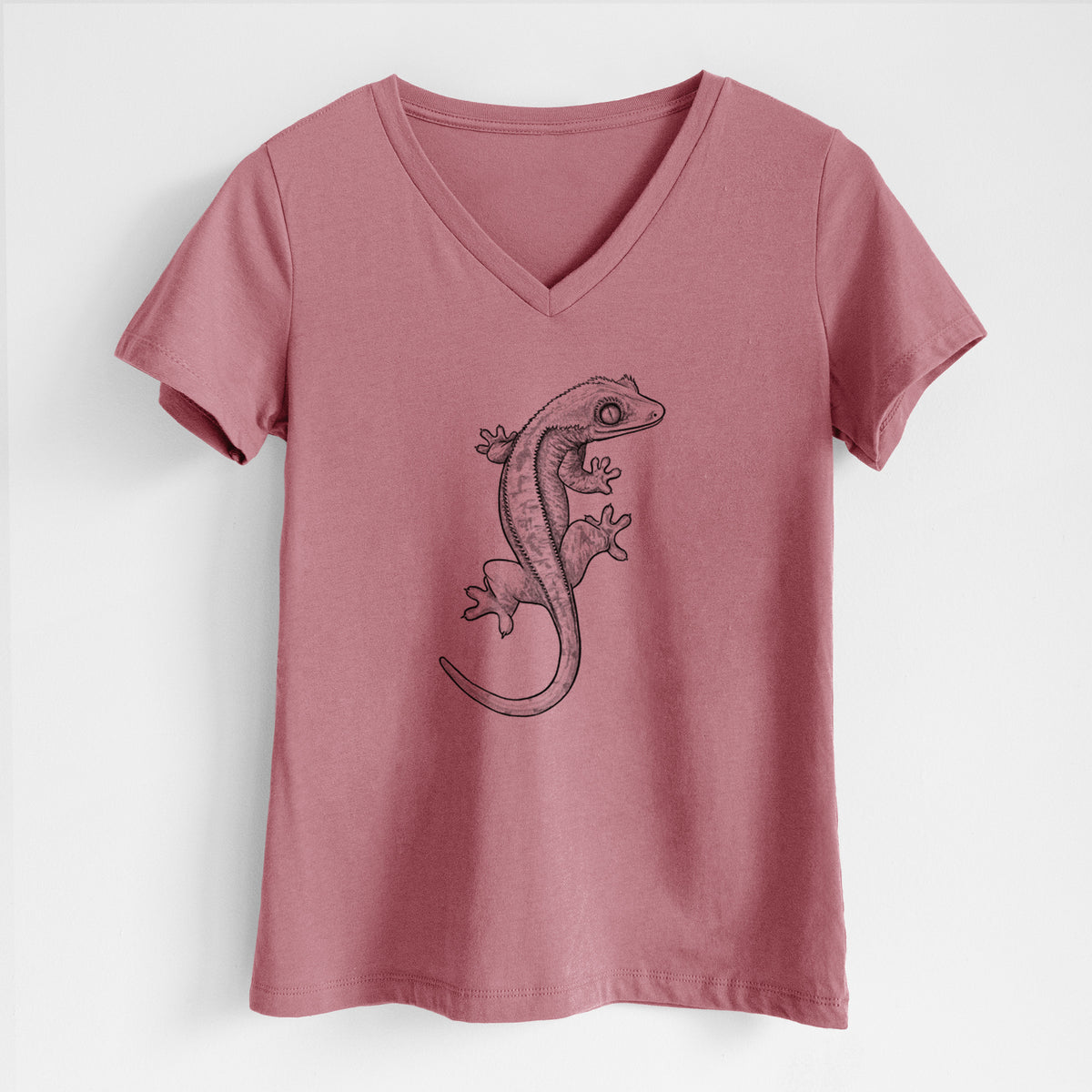 Mauve pink women's relaxed fit cotton V-neck t-shirt laid flat, printed with a detailed black ink illustration of a crested gecko climbing.
