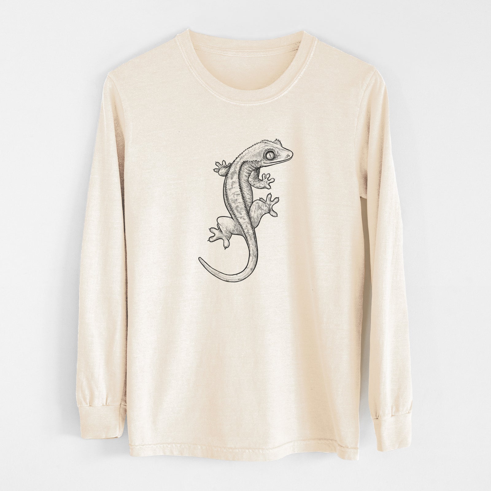 Ivory Comfort Colors long sleeve shirt laid flat, printed with a detailed black ink illustration of a crested gecko climbing.