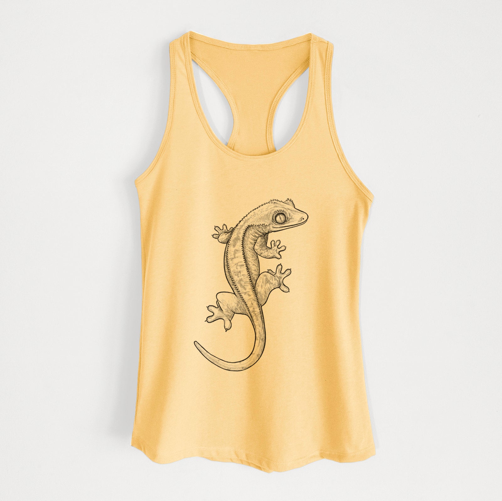 Banana cream women's racerback tank top laid flat, printed with a detailed black ink illustration of a crested gecko climbing.