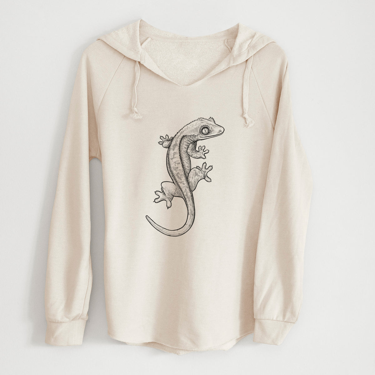 Bone cream women's Cali Wave hooded sweatshirt laid flat, printed with a detailed black ink illustration of a crested gecko climbing.