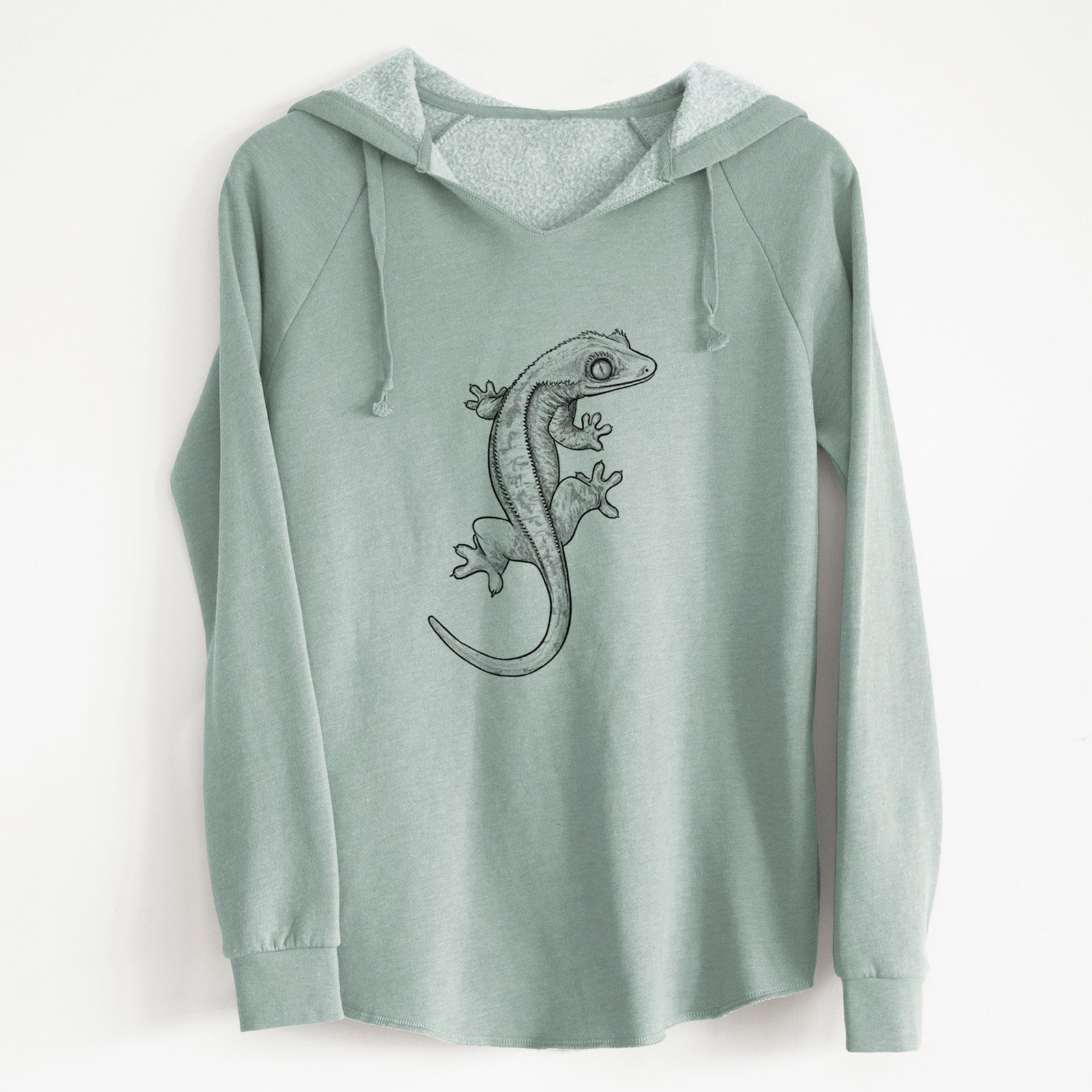 Sage green women's Cali Wave hooded sweatshirt laid flat, printed with a detailed black ink illustration of a crested gecko climbing.