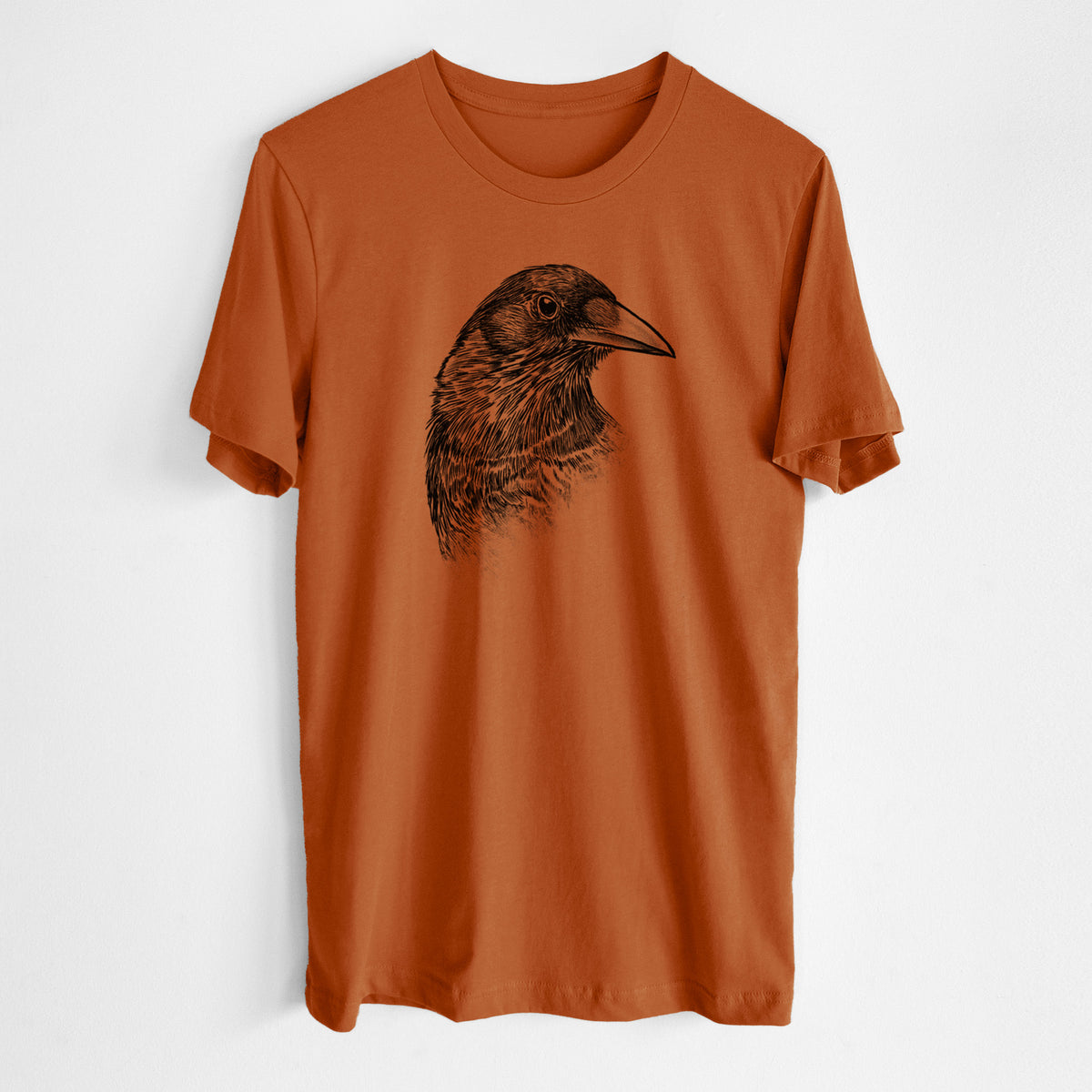 Autumn lightweight cotton t-shirt laid flat, printed with a detailed black ink portrait of a crow's head in profile.