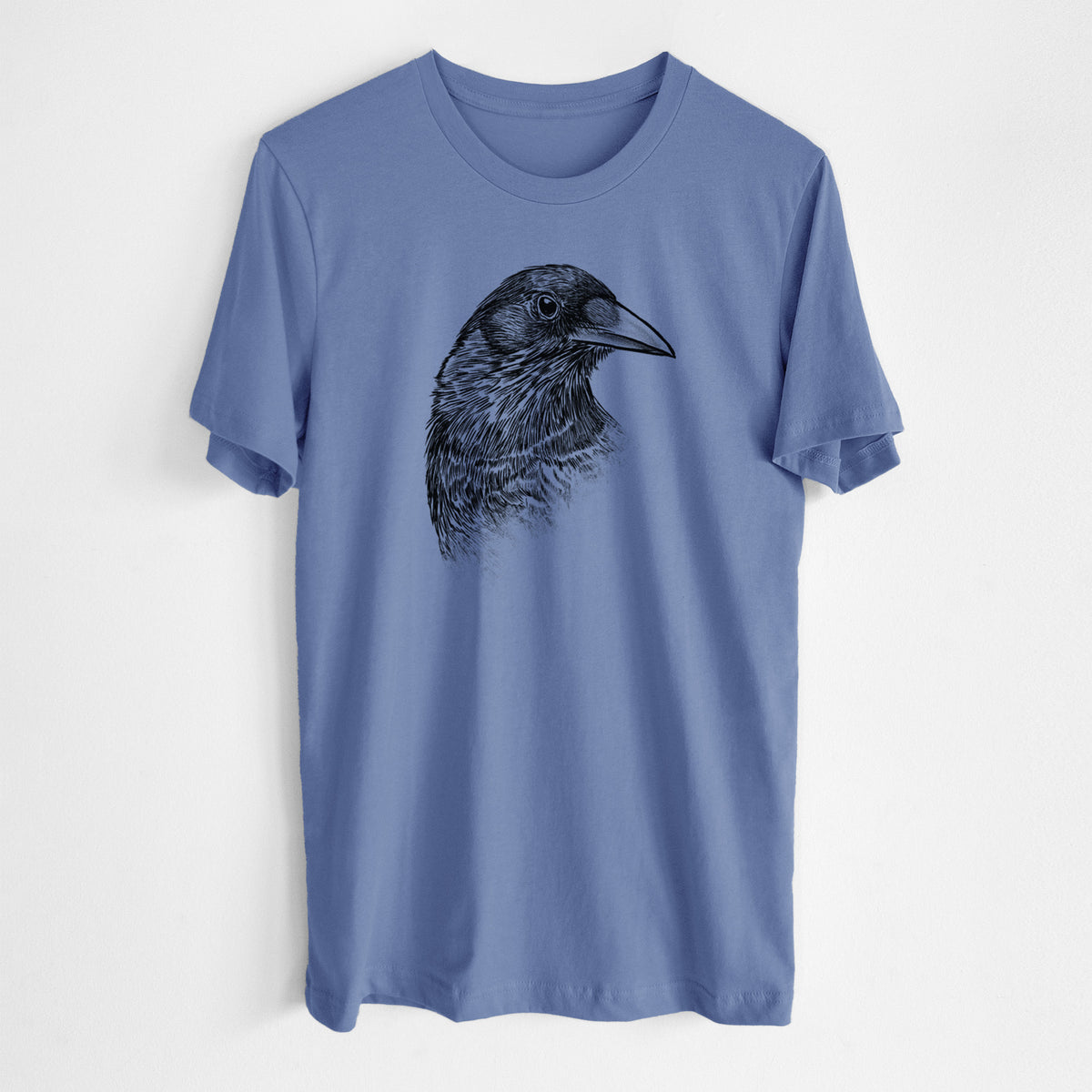 Blue bell lightweight cotton t-shirt laid flat, printed with a detailed black ink portrait of a crow's head in profile.