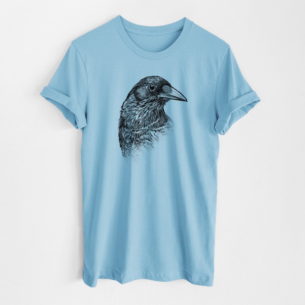 Ocean blue lightweight cotton t-shirt laid flat, printed with a detailed black ink portrait of a crow's head in profile.