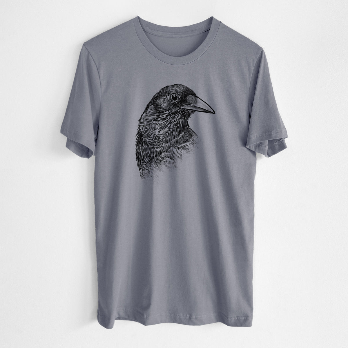 Storm grey lightweight cotton t-shirt laid flat, printed with a detailed black ink portrait of a crow's head in profile.