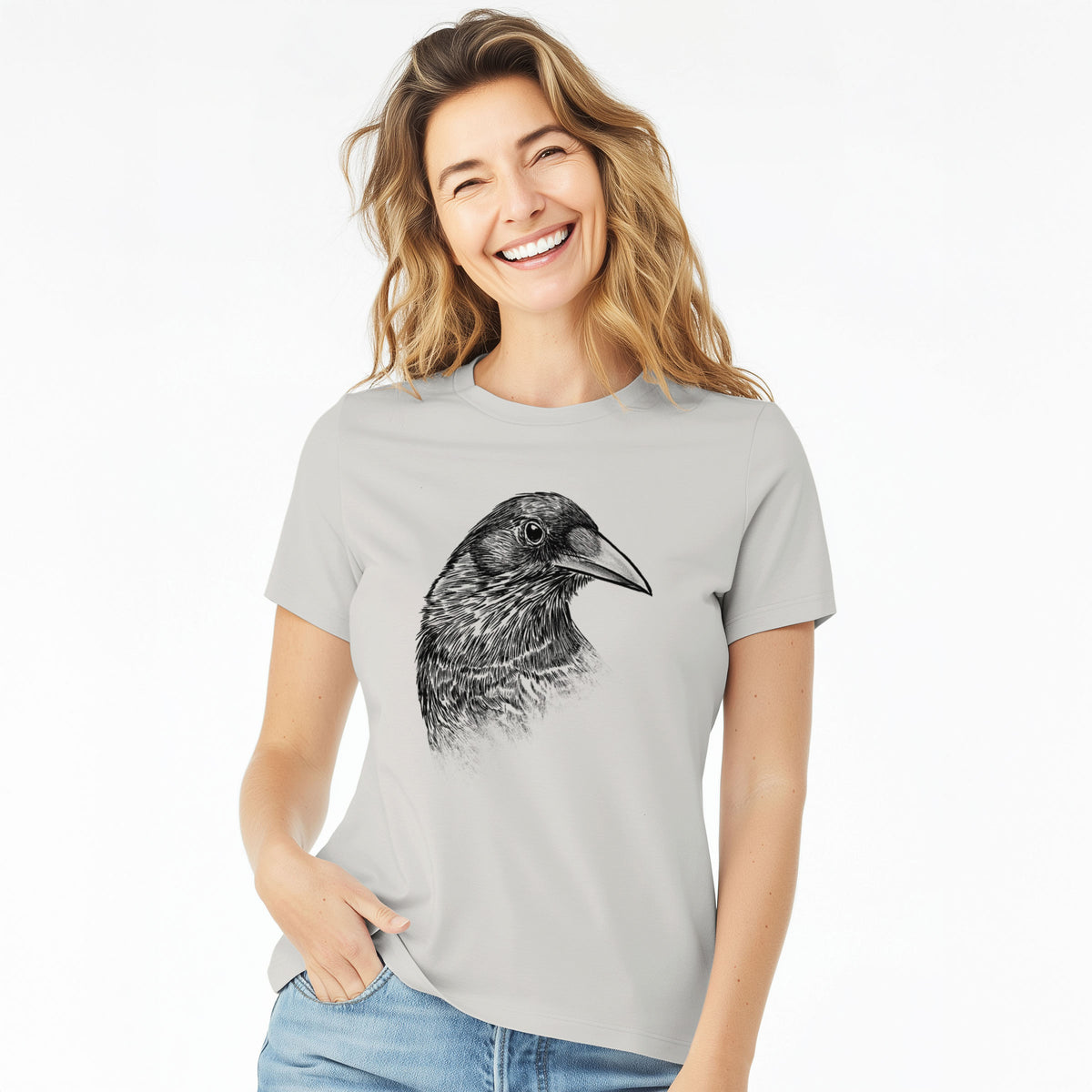 Woman wearing a lunar grey women's relaxed fit cotton t-shirt printed with a detailed black ink portrait of a crow's head in profile.
