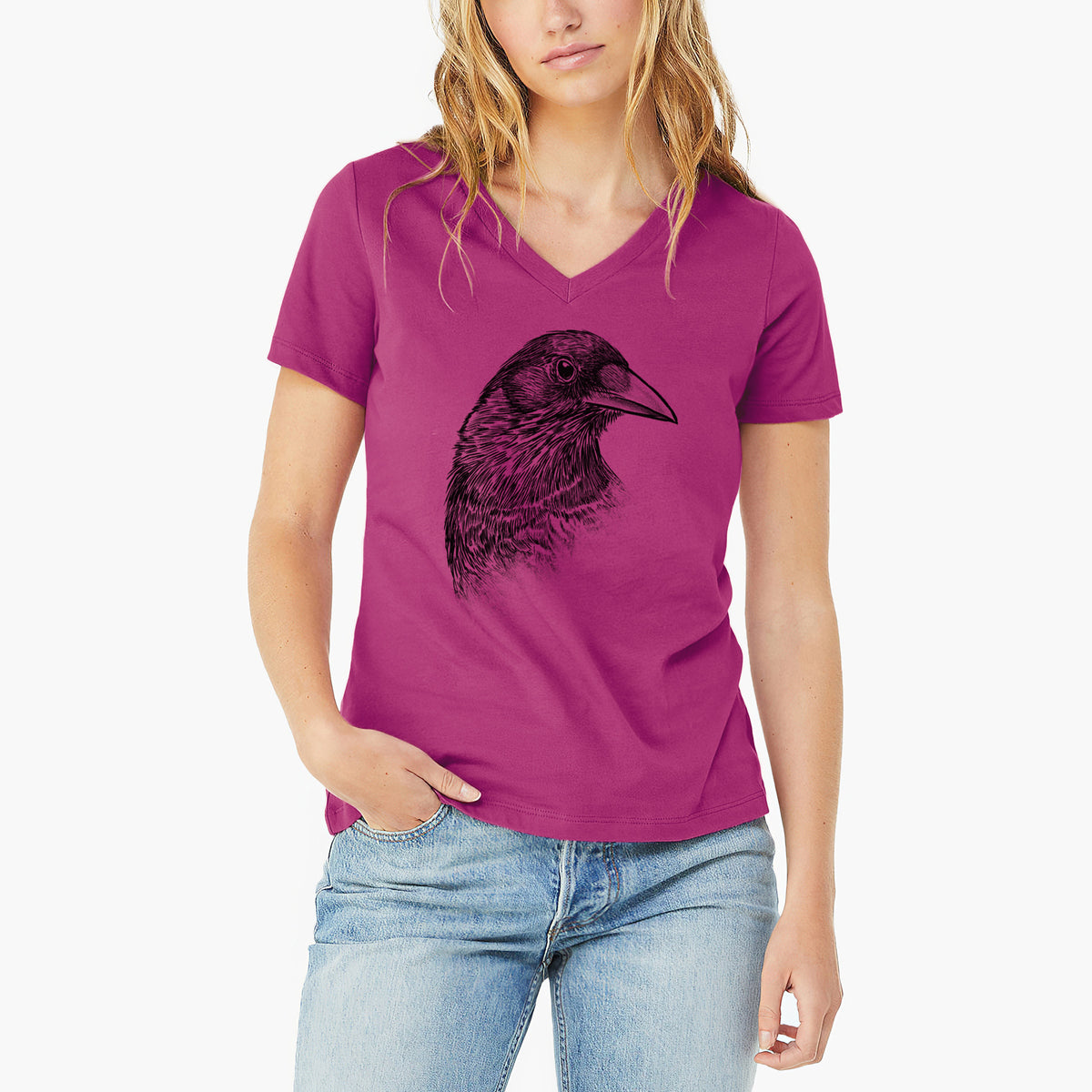 Woman wearing a berry pink women's relaxed fit cotton V-neck t-shirt printed with a detailed black ink portrait of a crow's head in profile.