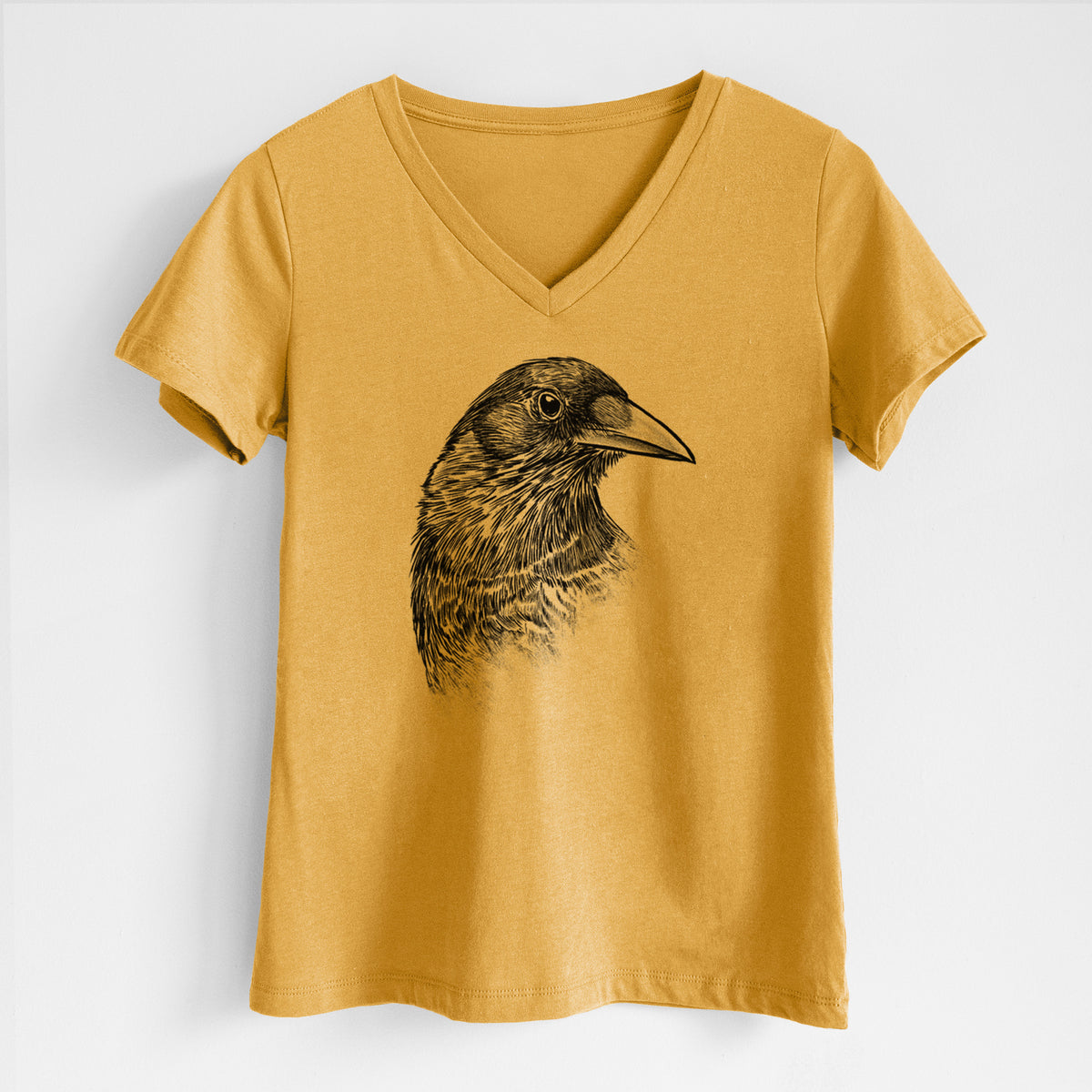 Honeycomb yellow women's relaxed fit cotton V-neck t-shirt laid flat, printed with a detailed black ink portrait of a crow's head in profile.