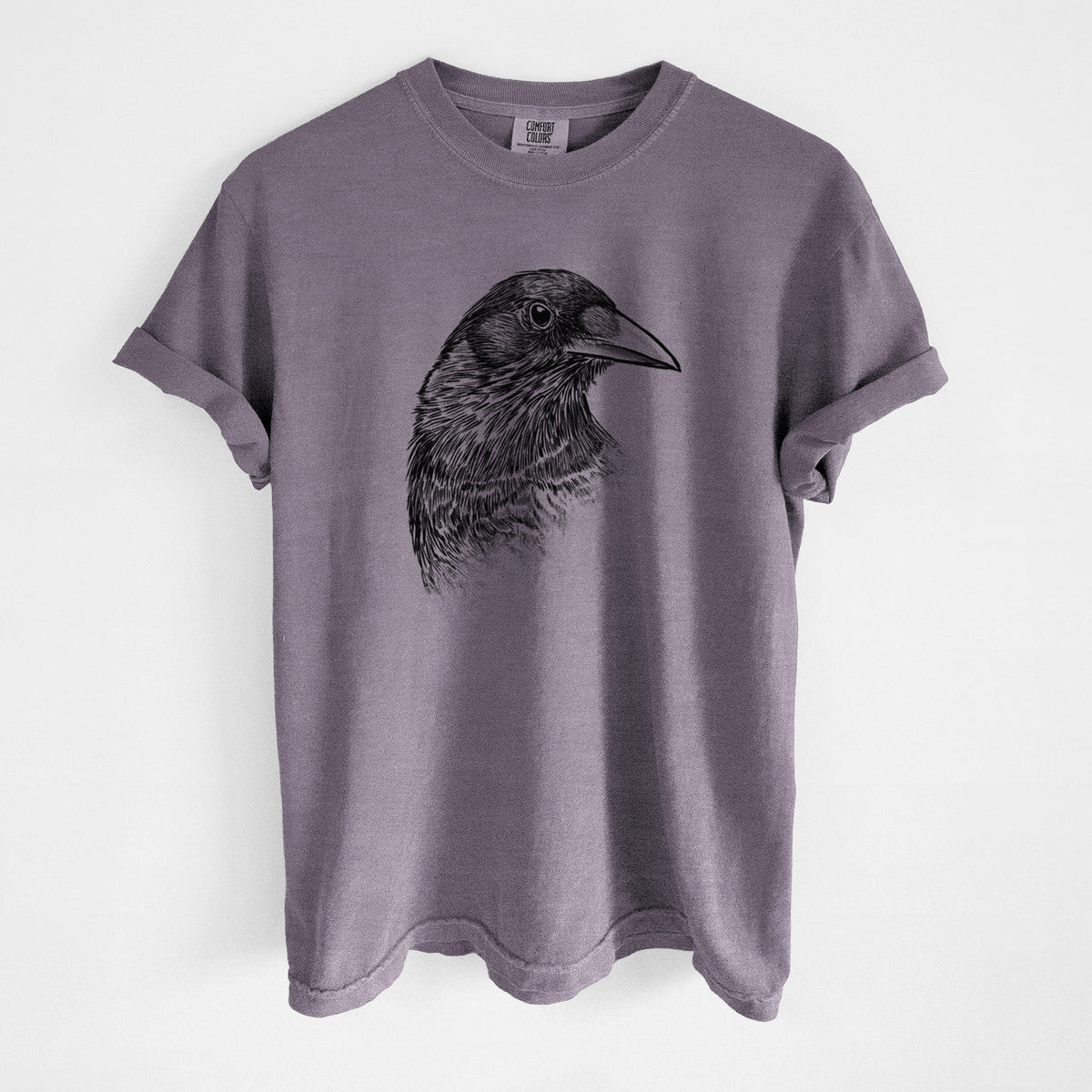 Wine red Comfort Colors t-shirt laid flat, printed with a detailed black ink portrait of a crow's head in profile.