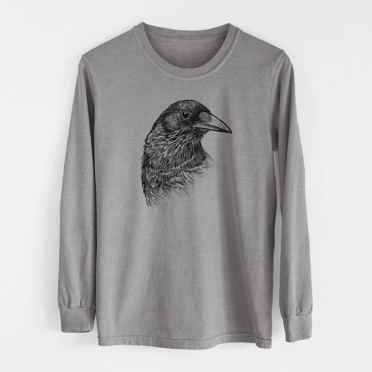 Grey Comfort Colors long sleeve shirt laid flat, printed with a detailed black ink portrait of a crow's head in profile.
