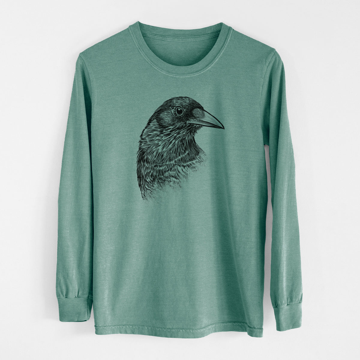 Pine green Comfort Colors long sleeve shirt laid flat, printed with a detailed black ink portrait of a crow's head in profile.