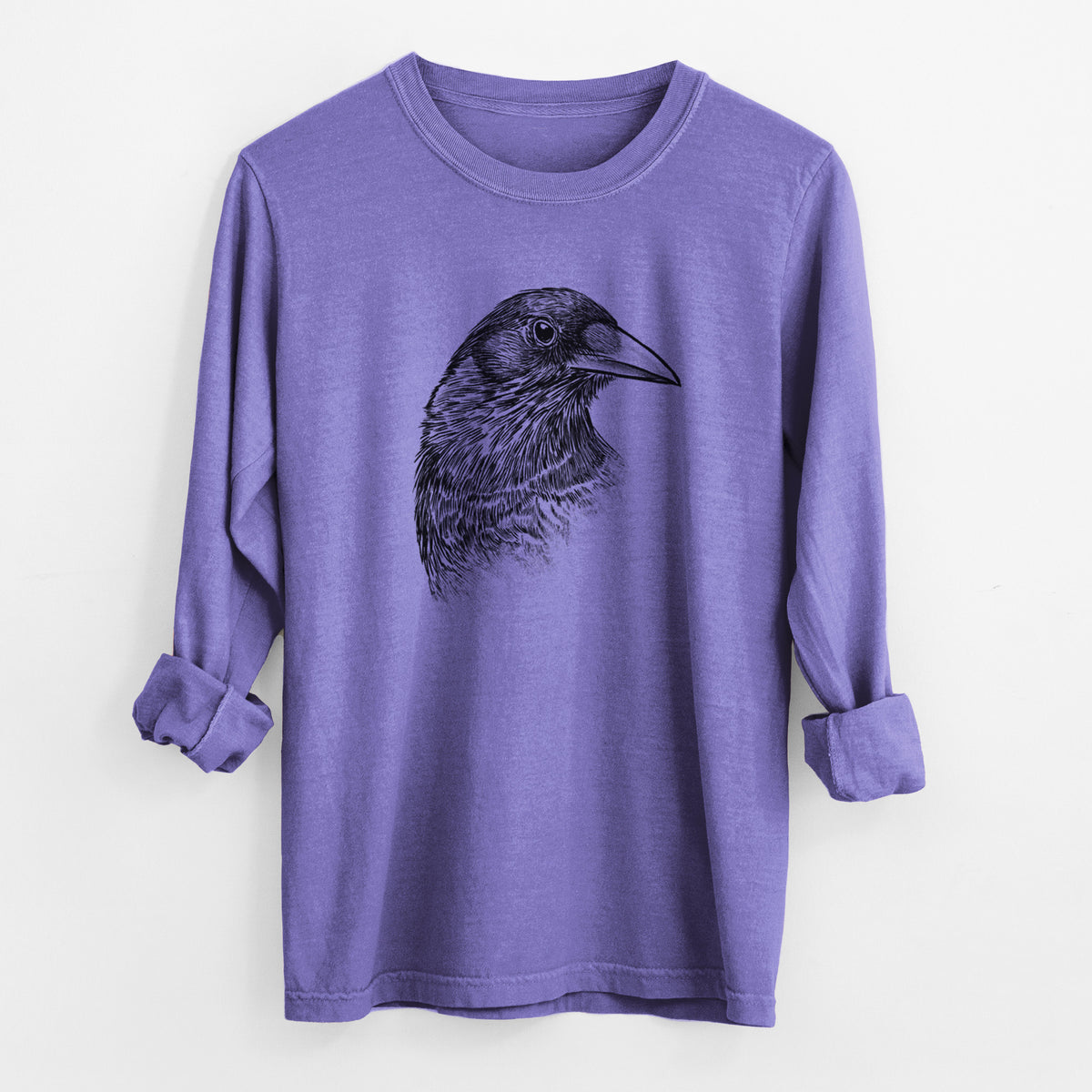 Violet purple Comfort Colors long sleeve shirt laid flat with the cuffs rolled, printed with a detailed black ink portrait of a crow's head in profile.
