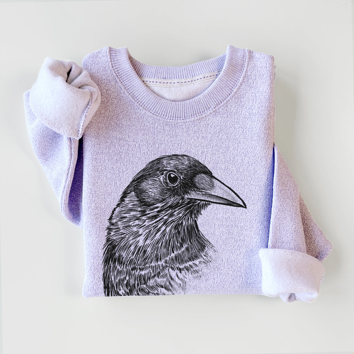 Ice purple knit sweatshirt printed with a detailed black ink portrait of a crow's head in profile, styled flat.