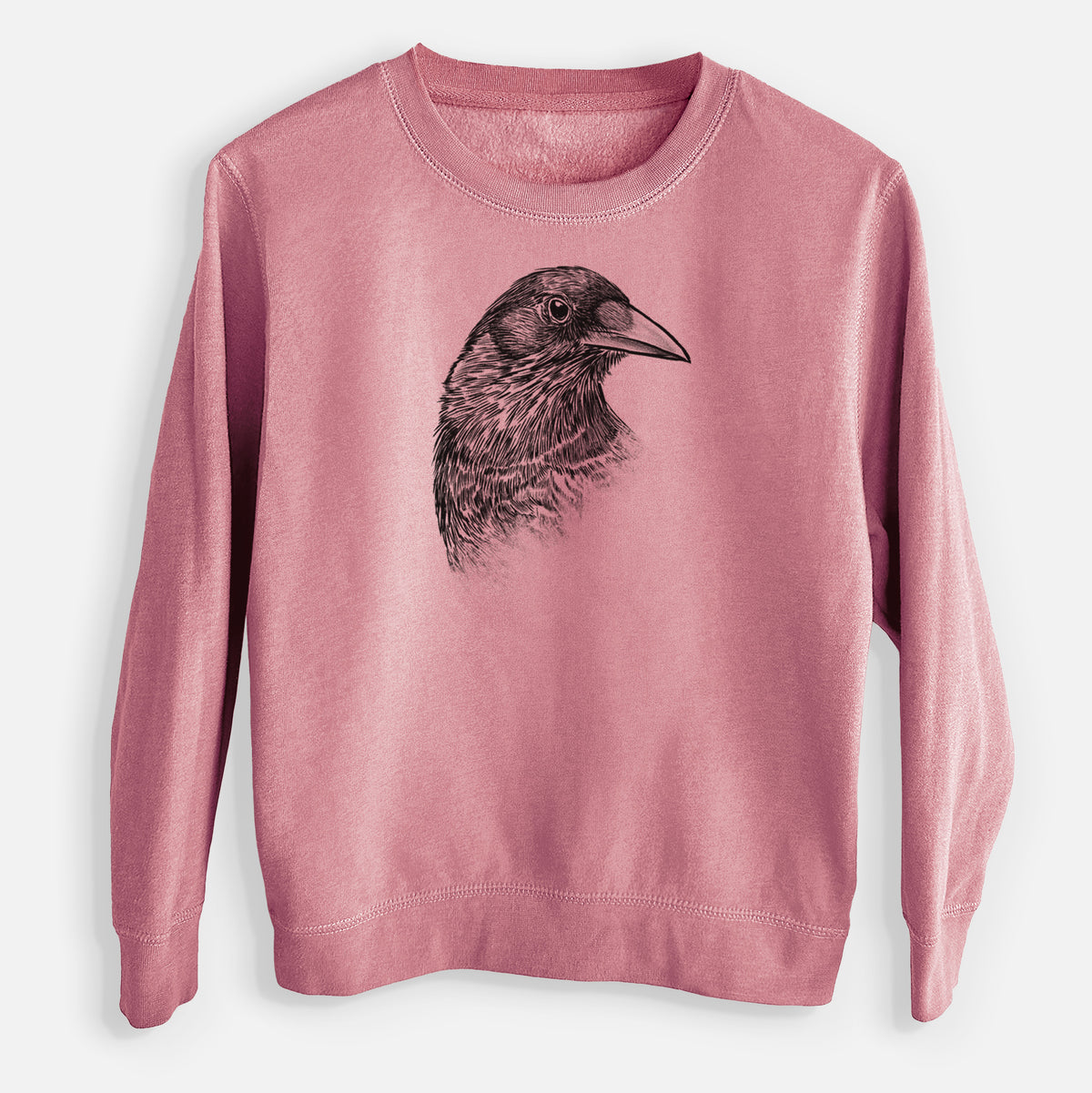 Mauve pink youth crewneck sweatshirt laid flat, printed with a detailed black ink portrait of a crow's head in profile.