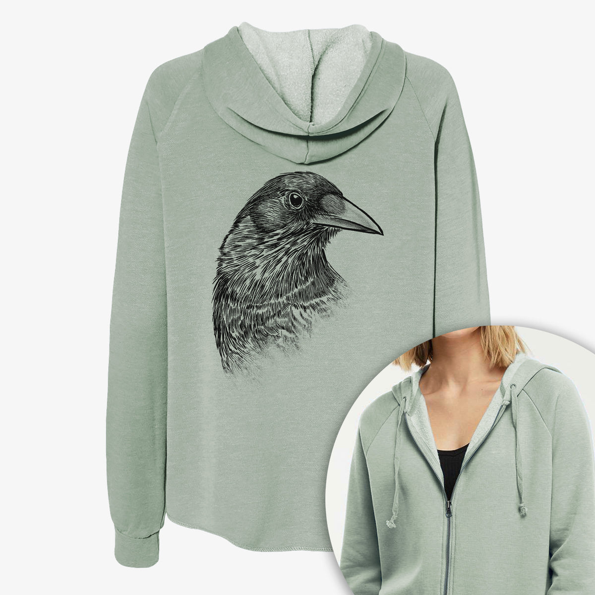 Women's Cali Wave zip-up sweatshirt printed with a detailed black ink portrait of a crow's head in profile, with a close-up of the zipper.