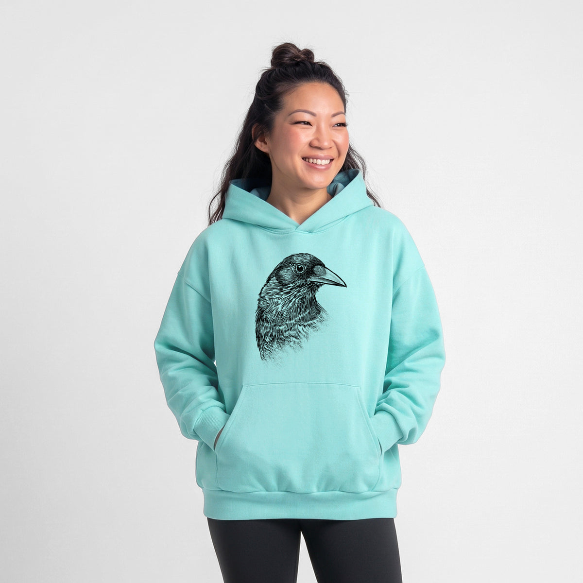 Female model wearing the American Crow Bust - Corvus brachyrhynchos - Statement Midweight Hoodie.