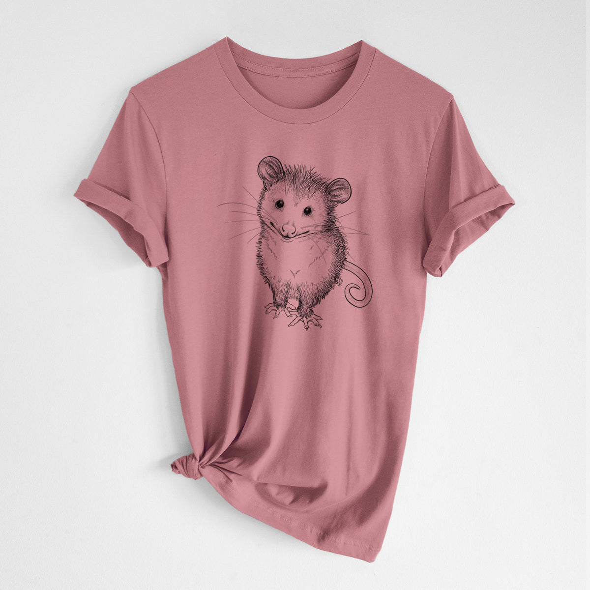 Mauve pink lightweight cotton t-shirt laid flat with the sleeves rolled, printed with a black ink illustration of a wide-eyed baby opossum sitting.