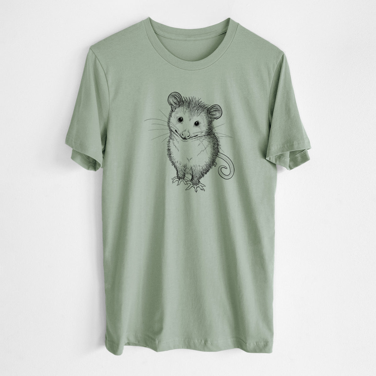 Sage green lightweight cotton t-shirt laid flat, printed with a black ink illustration of a wide-eyed baby opossum sitting.