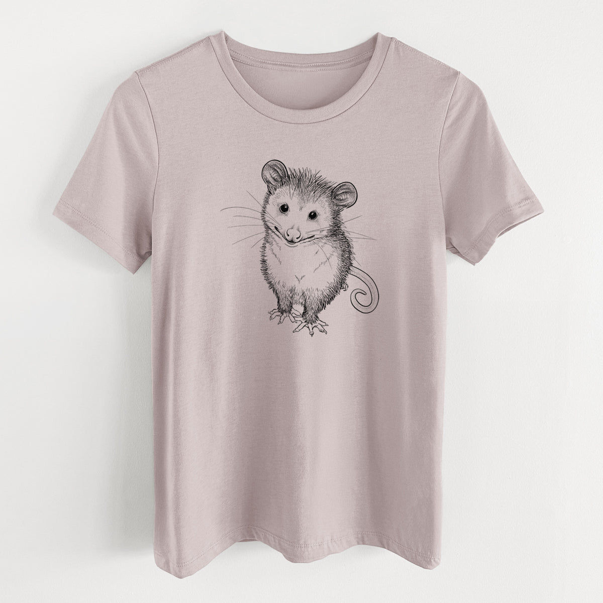 Pink gravel women's relaxed fit cotton t-shirt laid flat, printed with a black ink illustration of a wide-eyed baby opossum sitting.