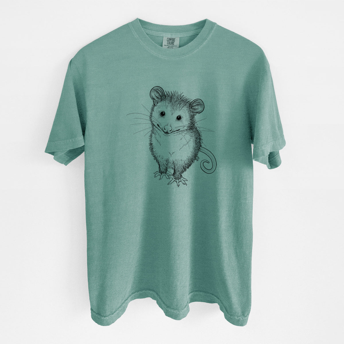 Reef green Comfort Colors t-shirt laid flat, printed with a black ink illustration of a wide-eyed baby opossum sitting.