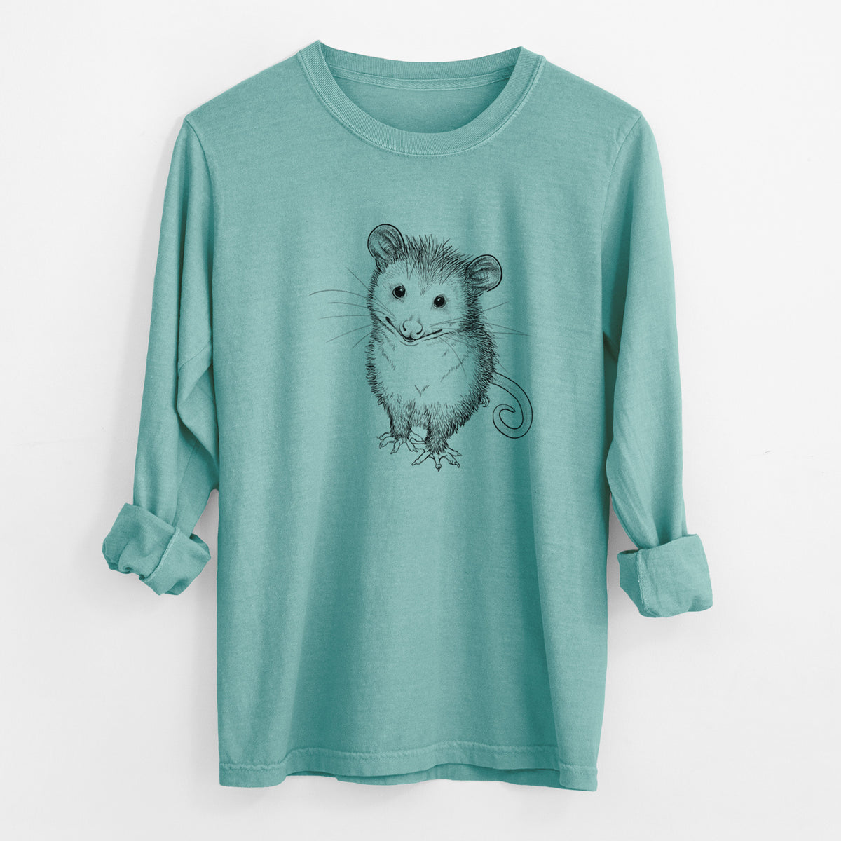Reef green Comfort Colors long sleeve shirt laid flat with the cuffs rolled, printed with a black ink illustration of a wide-eyed baby opossum sitting.